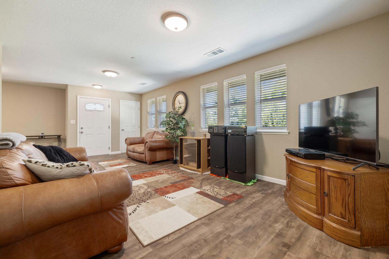 1255 Root Road Modesto, CA 95357 - Photo 12 of 52 a living room with furniture and a flat screen tv