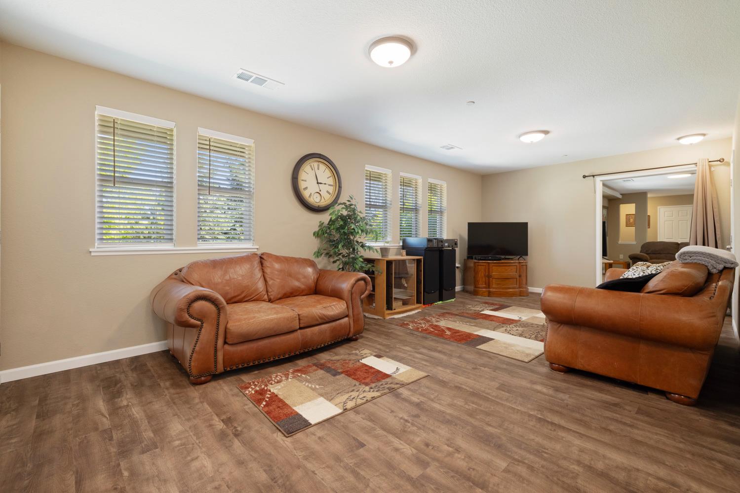 1255 Root Road Modesto, CA 95357 - Photo 13 of 52 a living room with furniture a flat screen tv and a large window