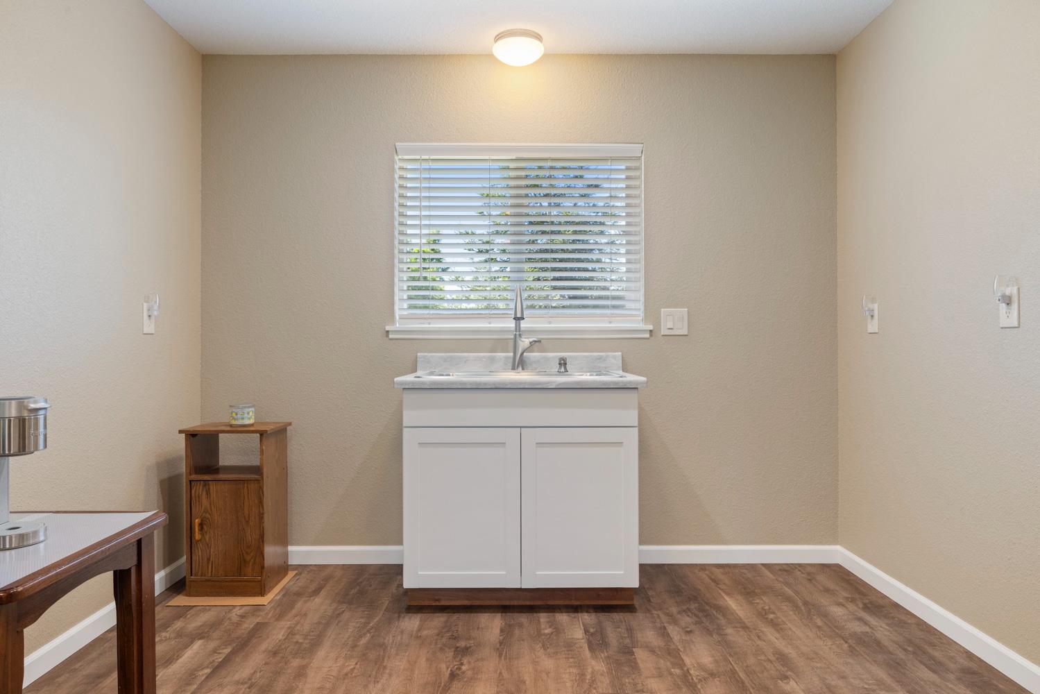 1255 Root Road Modesto, CA 95357 - Photo 16 of 52 a view of an empty room with wooden floor and a window