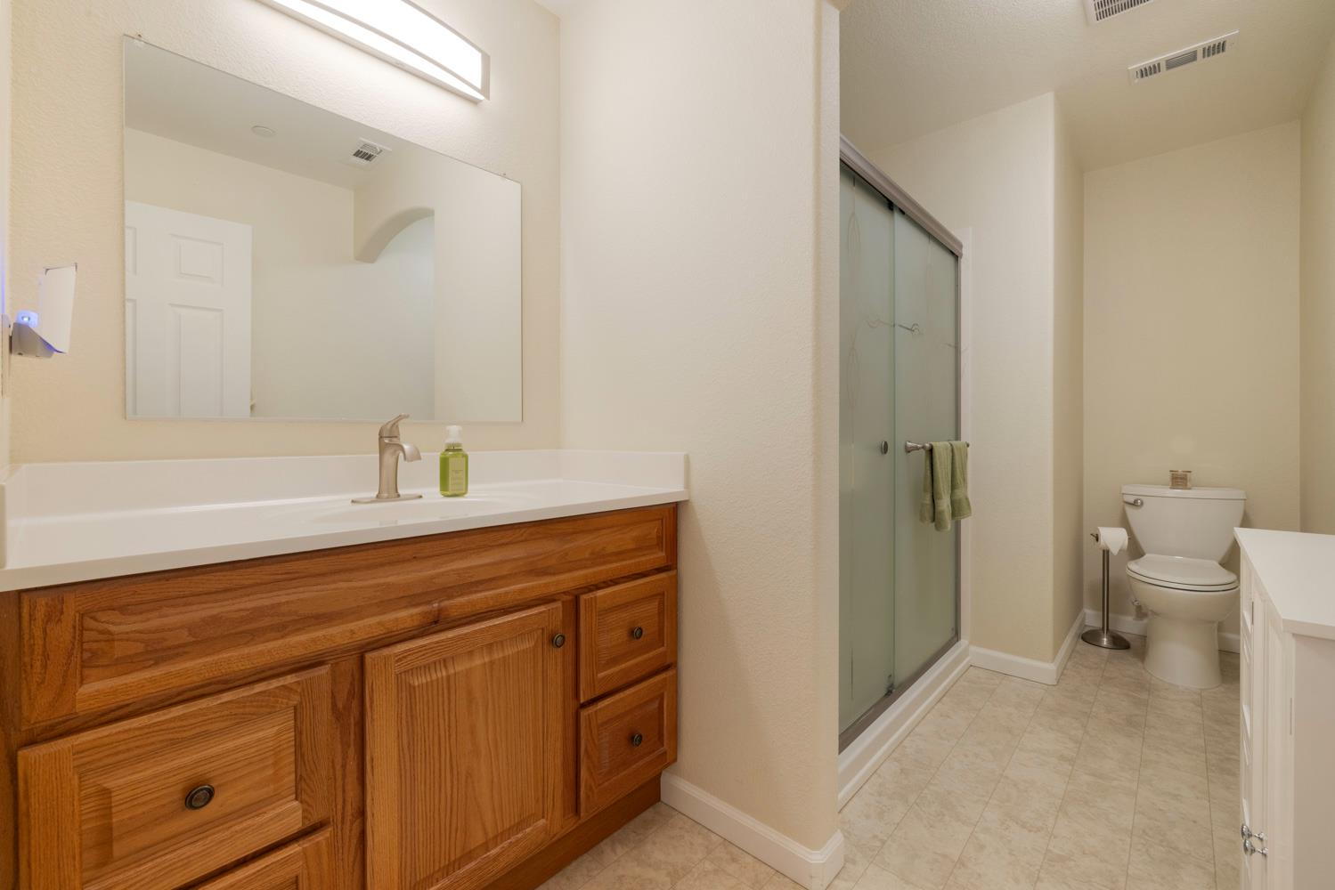 1255 Root Road Modesto, CA 95357 - Photo 18 of 52 a bathroom with a sink a toilet and shower