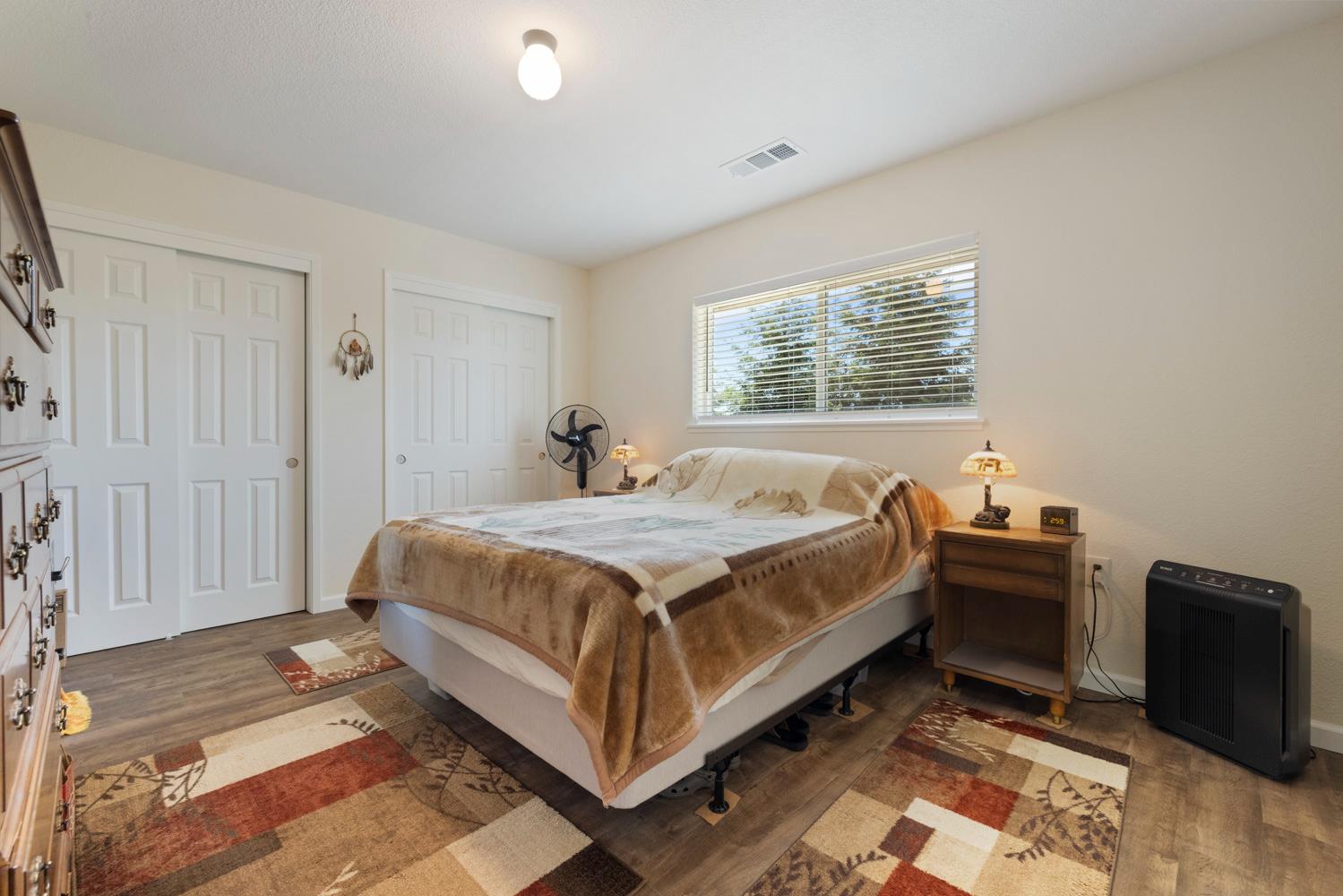 1255 Root Road Modesto, CA 95357 - Photo 19 of 52 a large bed sitting in a spacious bedroom next to a window
