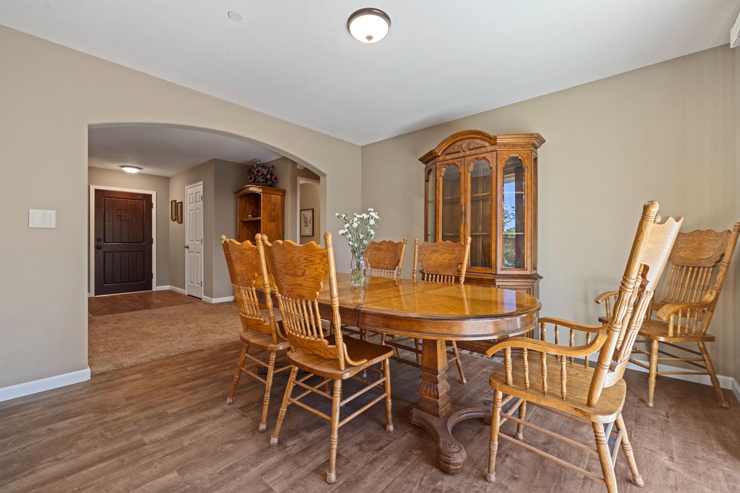 1255 Root Road Modesto, CA 95357 - Photo 24 of 52 a view of a dining room with furniture and wooden floor