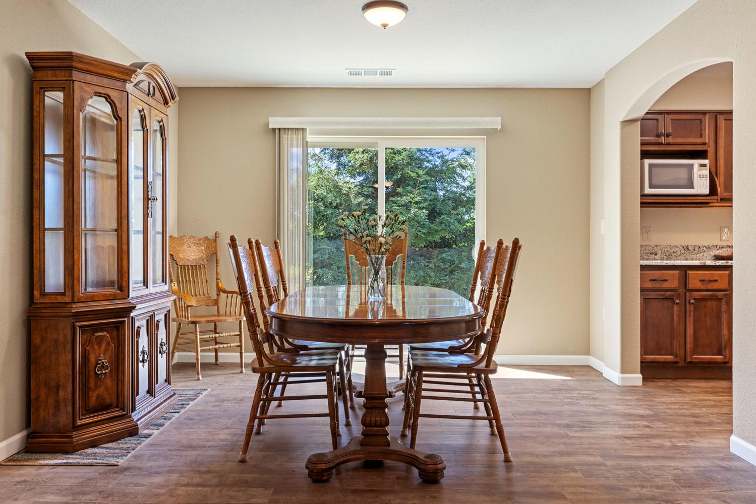 1255 Root Road Modesto, CA 95357 - Photo 25 of 52 a view of a dining room with furniture window and wooden floor