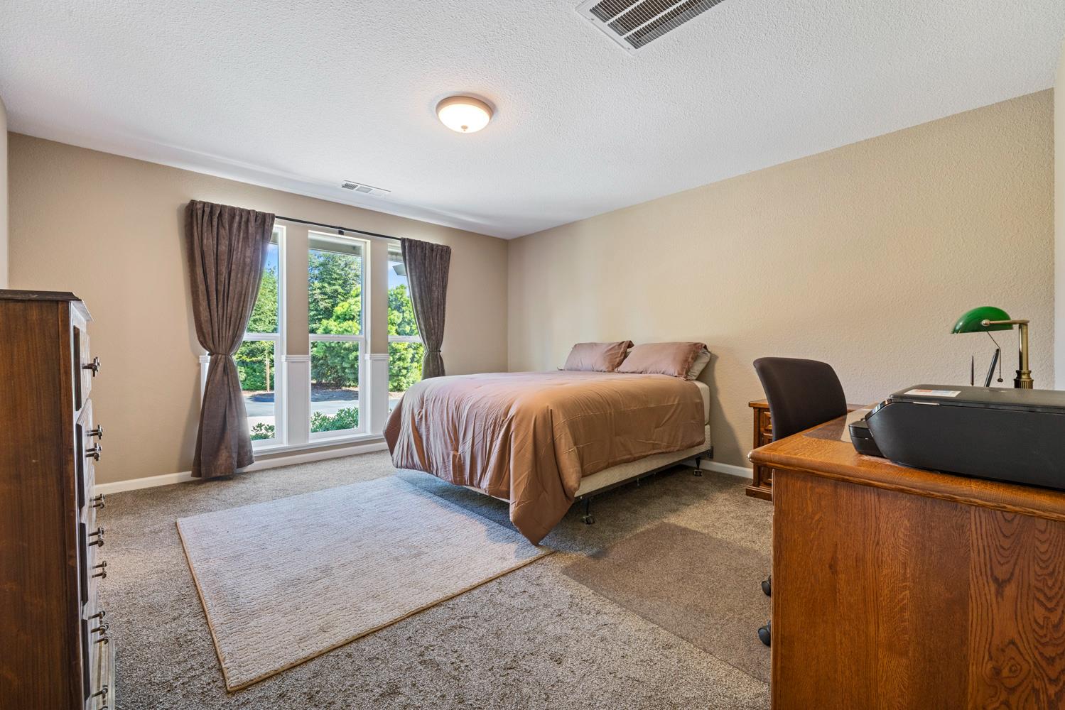 1255 Root Road Modesto, CA 95357 - Photo 31 of 52 a spacious bedroom with two beds and large window