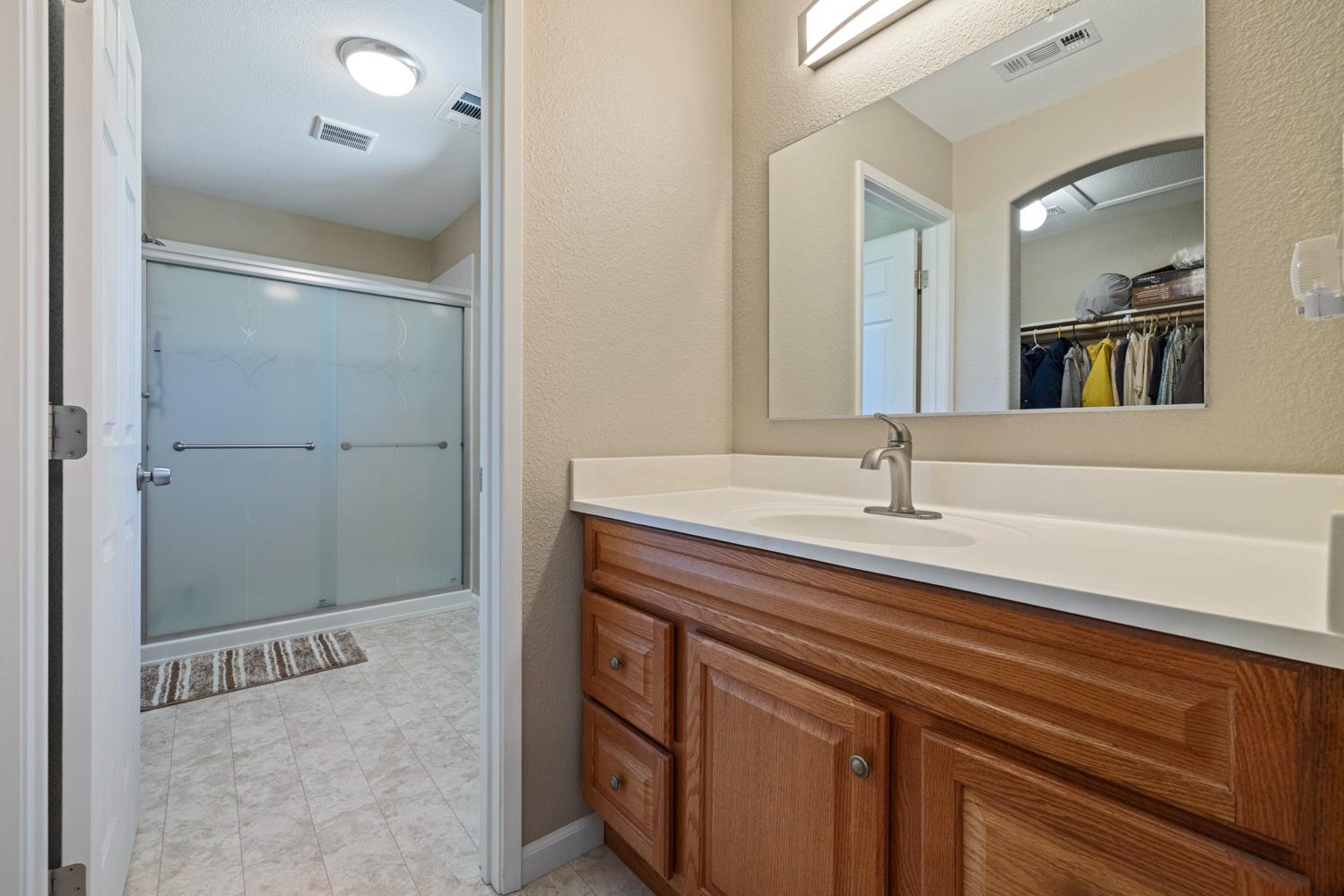 1255 Root Road Modesto, CA 95357 - Photo 32 of 52 a bathroom with a sink and a mirror