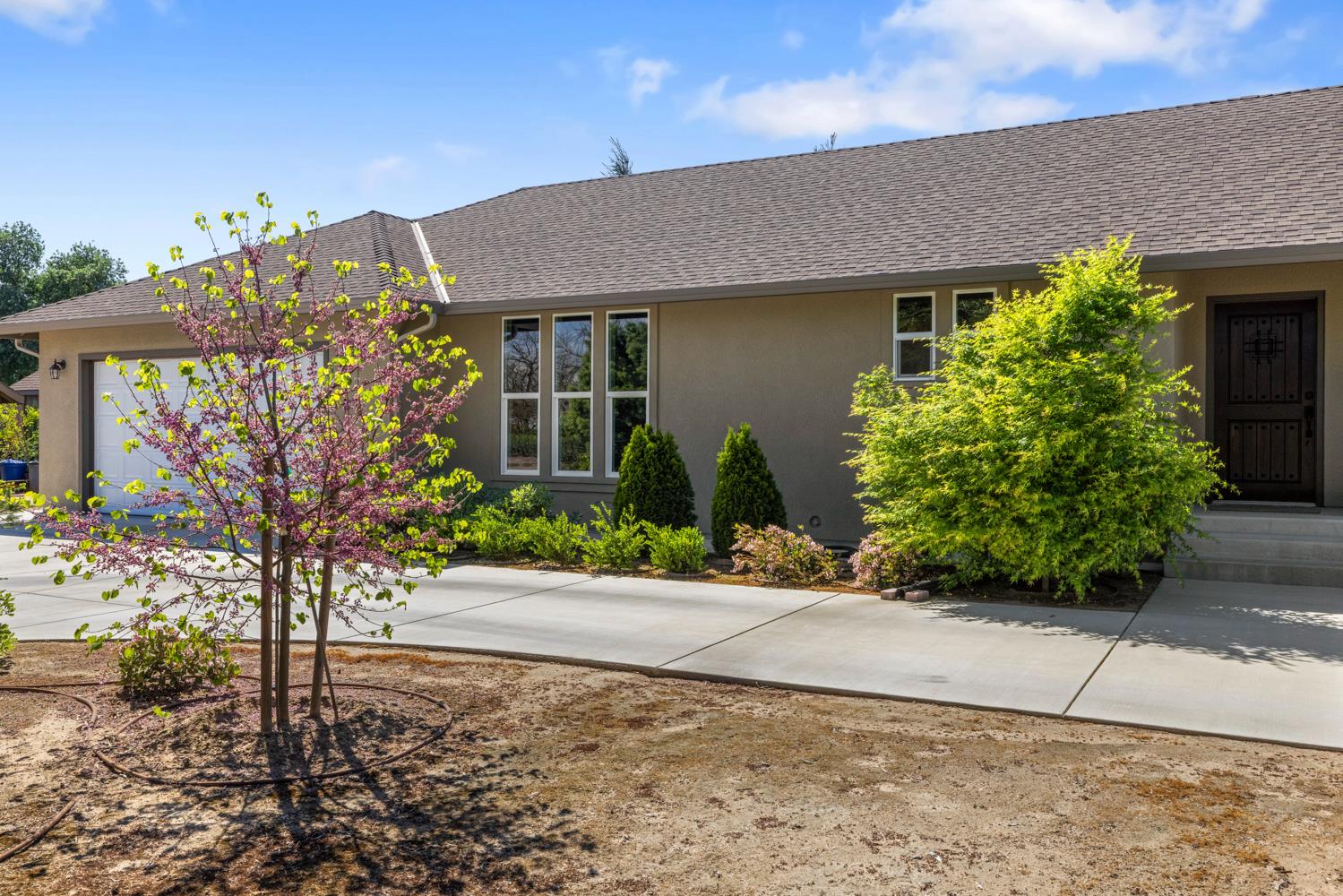 1255 Root Road Modesto, CA 95357 - Photo 4 of 52 a front view of a house with garden