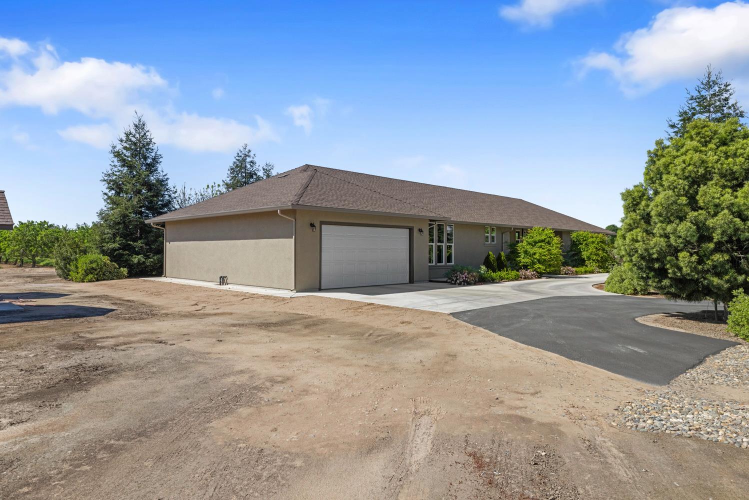 1255 Root Road Modesto, CA 95357 - Photo 5 of 52 a front view of a house with a yard and garage