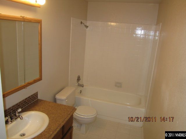 3916 Kings Row Reno, NV 89503 - Photo 9 of 10 a bathroom with a granite countertop sink toilet and shower
