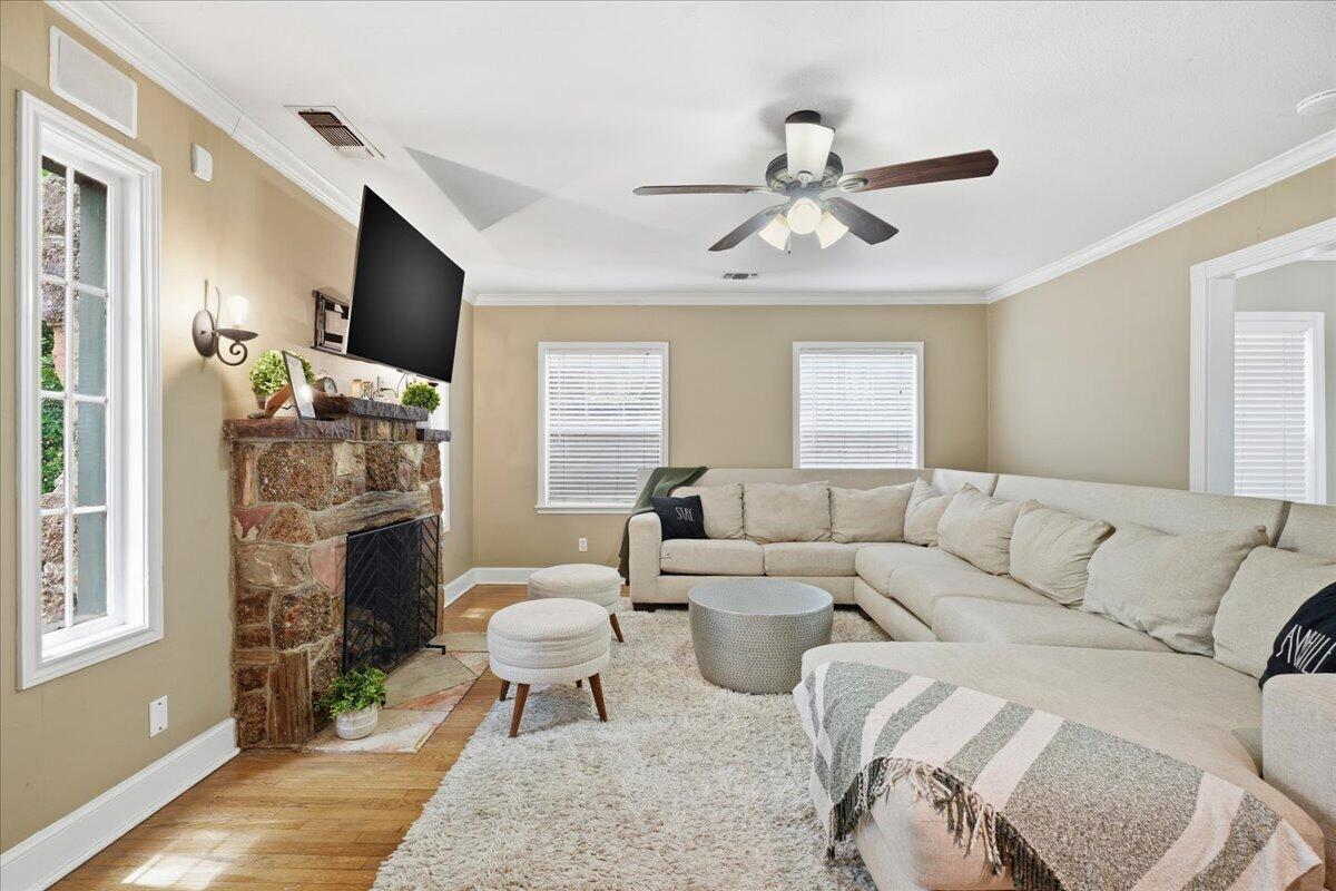 2702 20th Street Lubbock, TX 79410 - Photo 3 of 34 a living room with furniture a fireplace and a flat screen tv