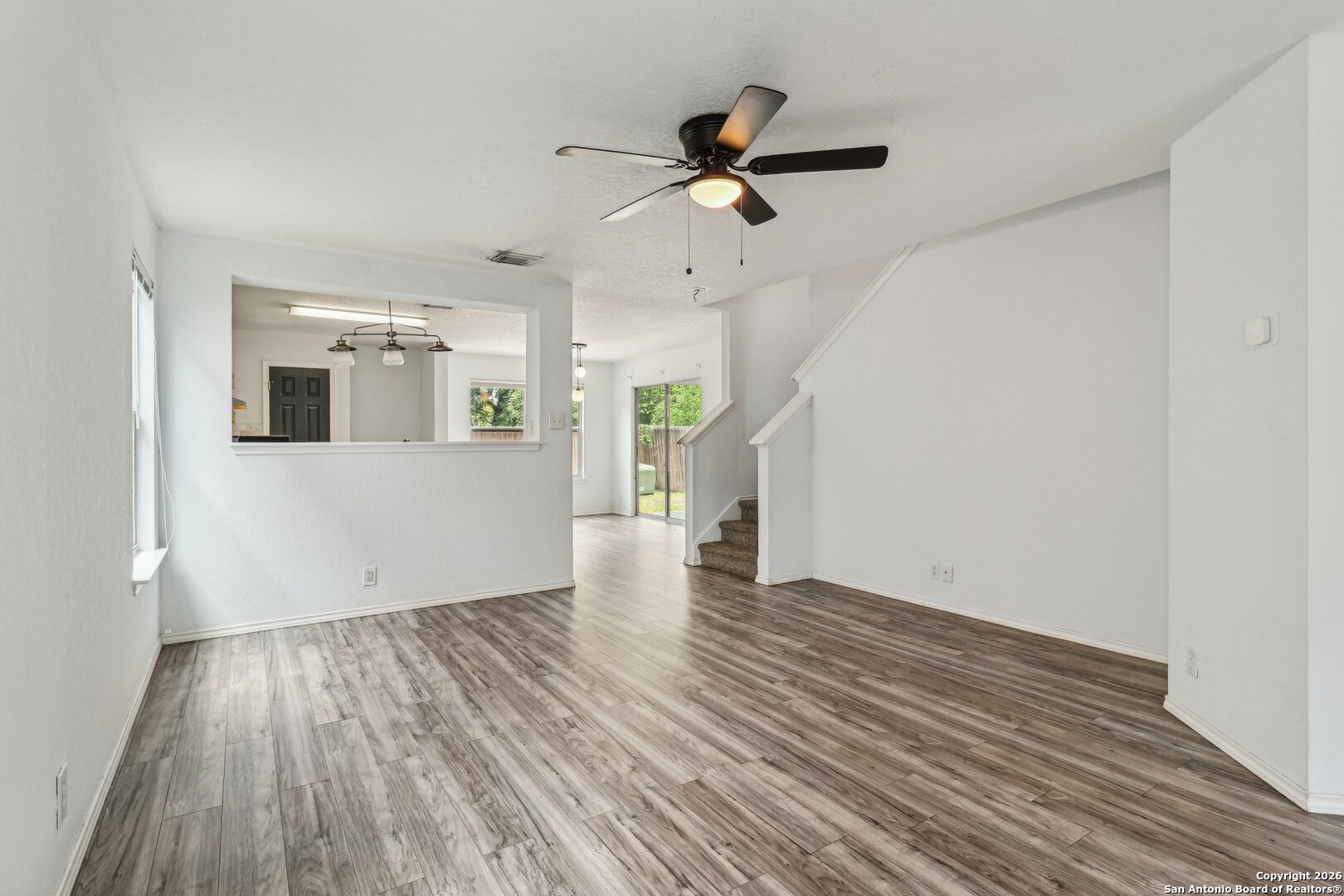 87 Kenrock Ridge San Antonio, TX 78254 - Photo 13 of 50 a view of empty room with wooden floor and ceiling fan