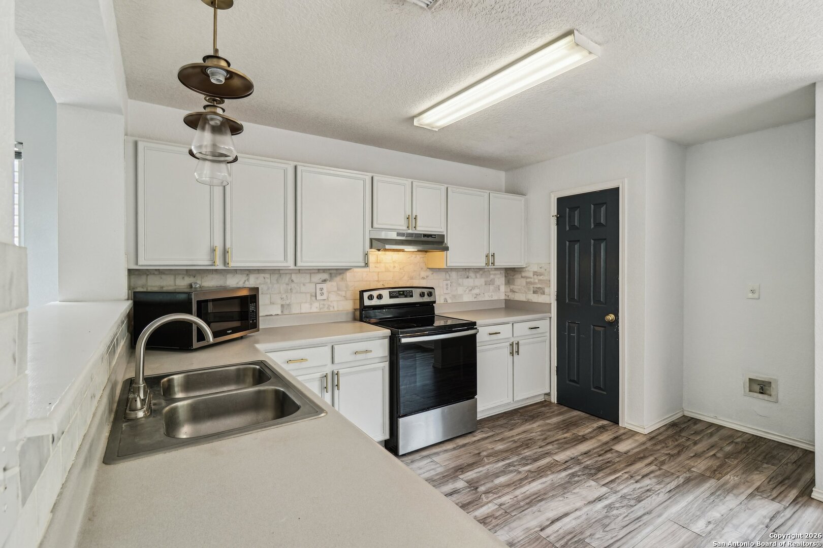 87 Kenrock Ridge San Antonio, TX 78254 - Photo 14 of 50 a kitchen with granite countertop a sink stainless steel appliances and cabinets