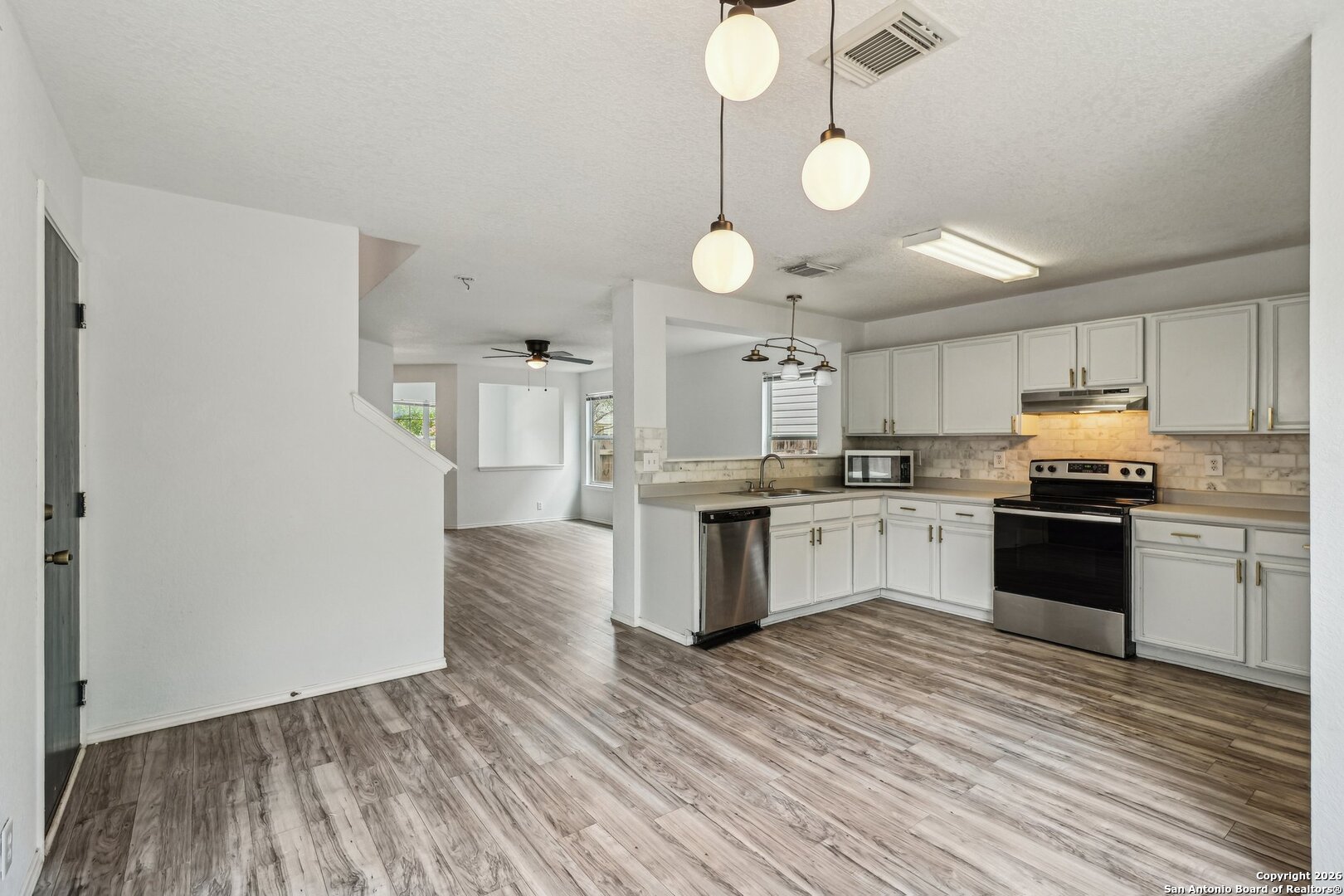 87 Kenrock Ridge San Antonio, TX 78254 - Photo 16 of 50 a kitchen with granite countertop a stove top oven and cabinets