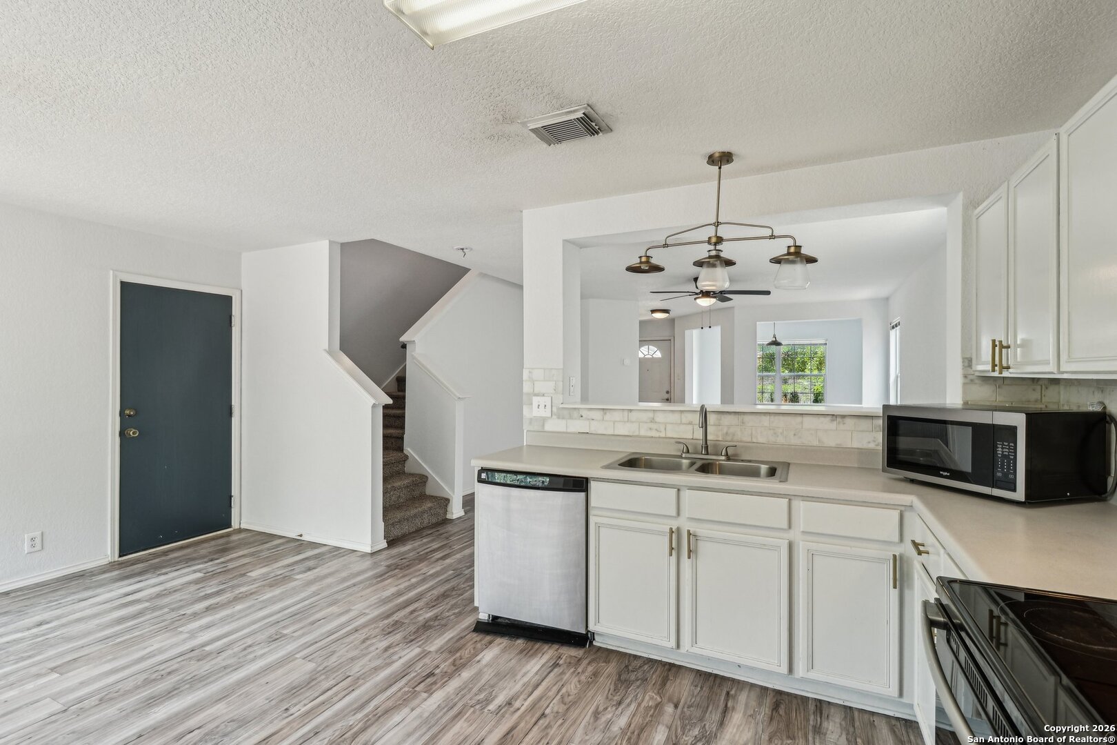 87 Kenrock Ridge San Antonio, TX 78254 - Photo 17 of 50 a kitchen with kitchen island granite countertop a sink cabinets and stainless steel appliances