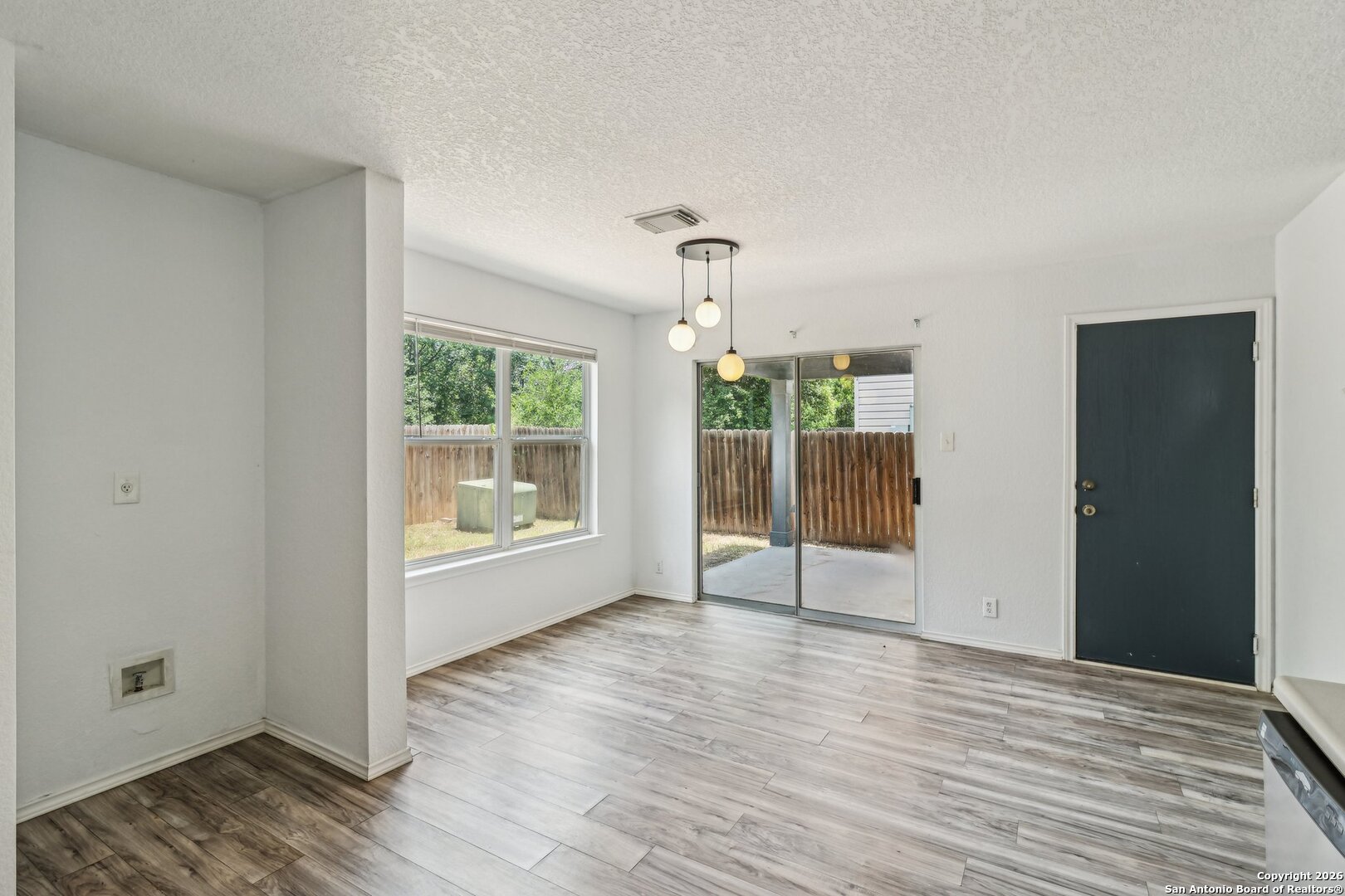 87 Kenrock Ridge San Antonio, TX 78254 - Photo 20 of 50 a view of an empty room with wooden floor and a window