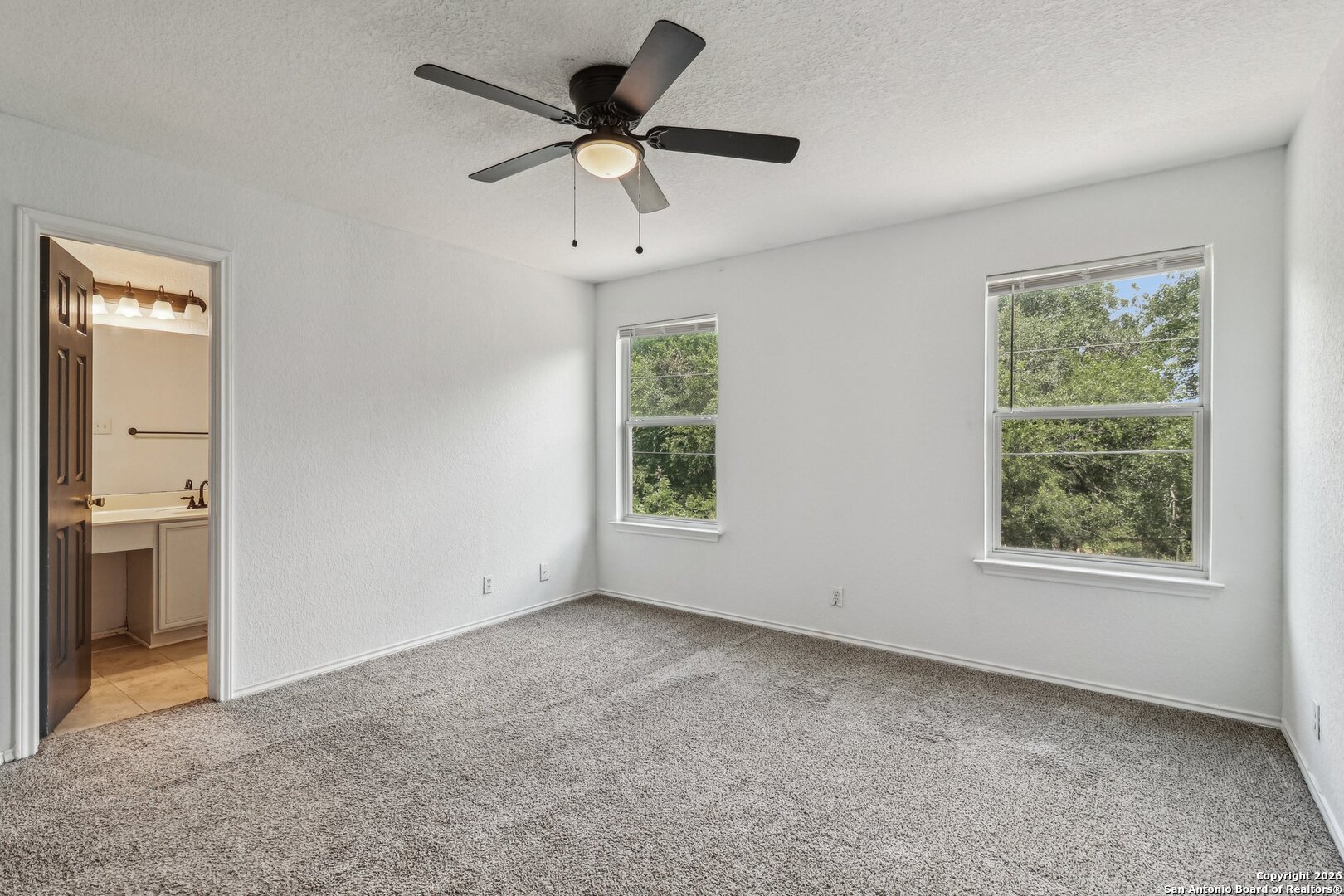87 Kenrock Ridge San Antonio, TX 78254 - Photo 25 of 50 an empty room with a window and a ceiling fan