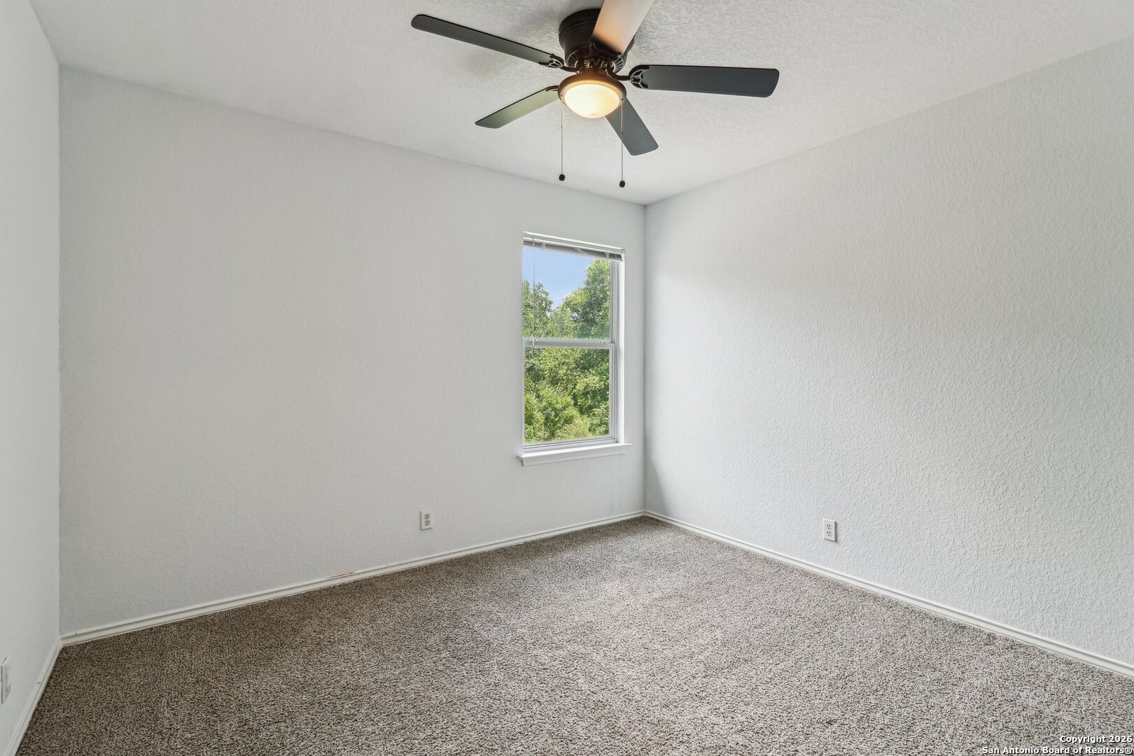 87 Kenrock Ridge San Antonio, TX 78254 - Photo 28 of 50 an empty room with a window and a fan