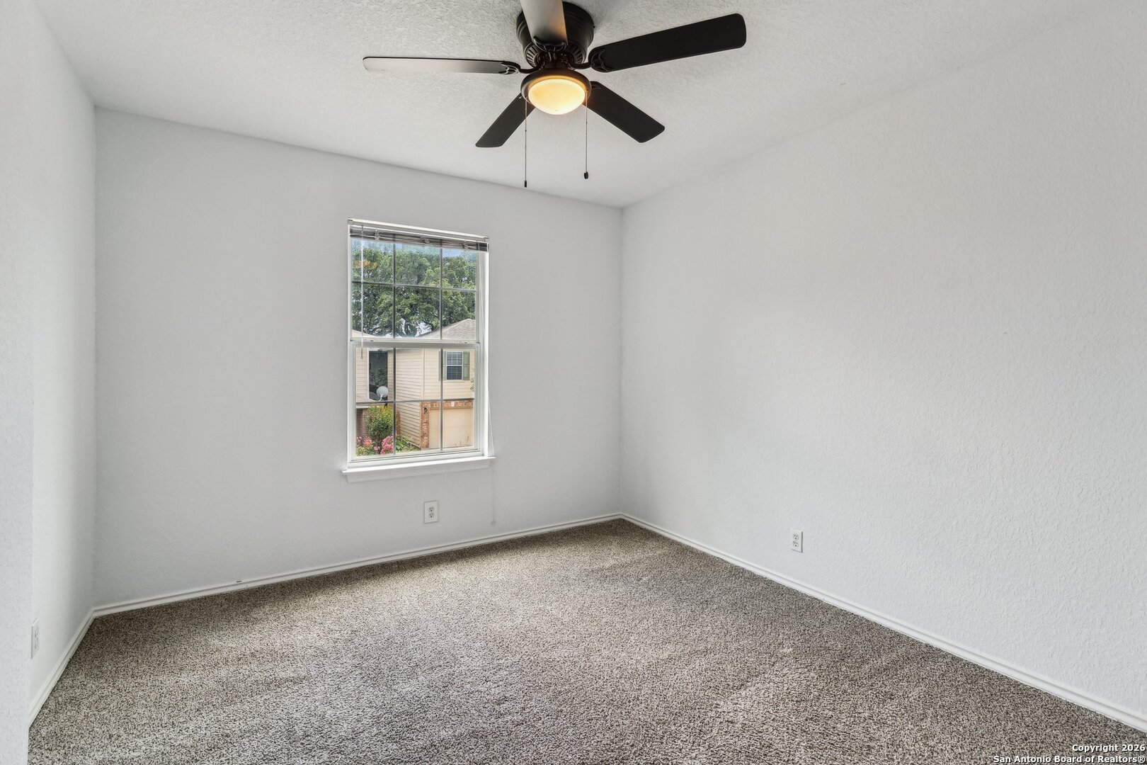 87 Kenrock Ridge San Antonio, TX 78254 - Photo 30 of 50 an empty room with chandelier fan and windows