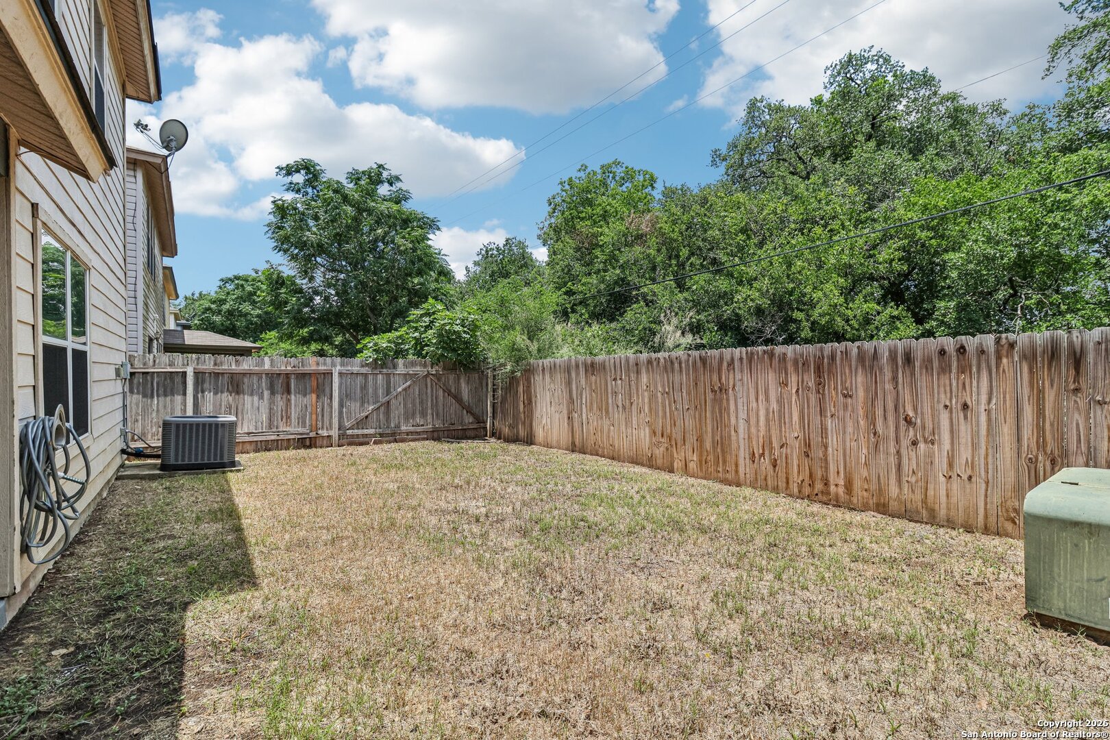 87 Kenrock Ridge San Antonio, TX 78254 - Photo 40 of 50 a backyard of a house with lots of green space