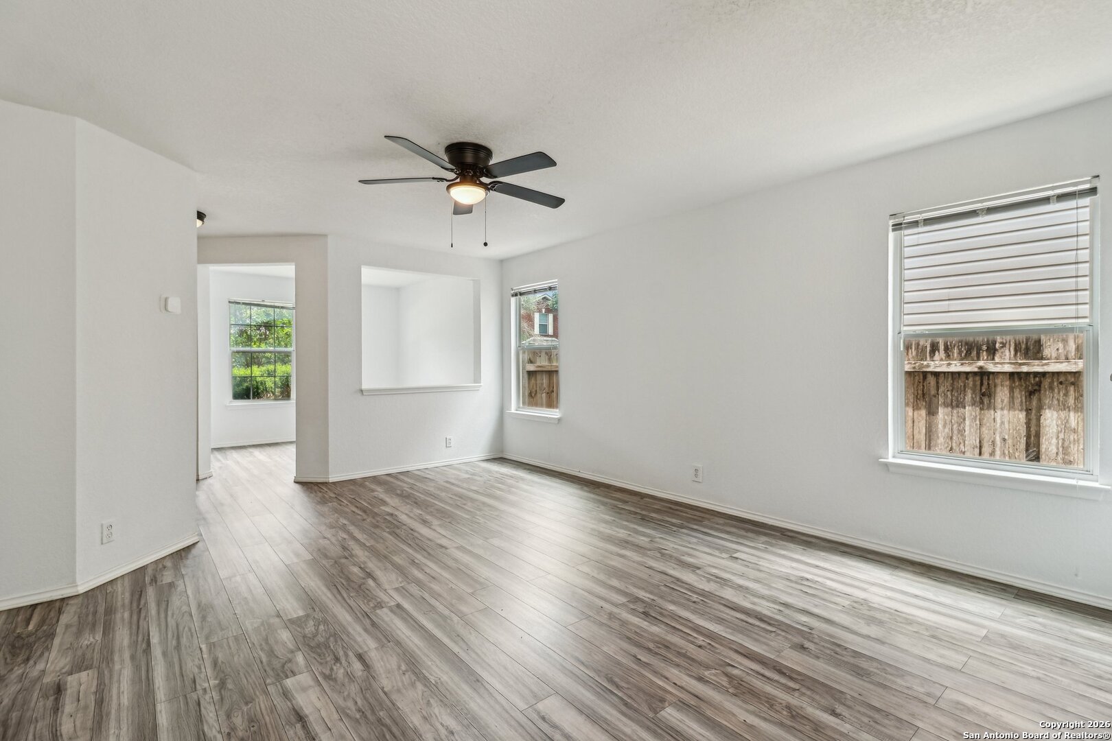 87 Kenrock Ridge San Antonio, TX 78254 - Photo 8 of 50 a view of an empty room with a window and wooden floor
