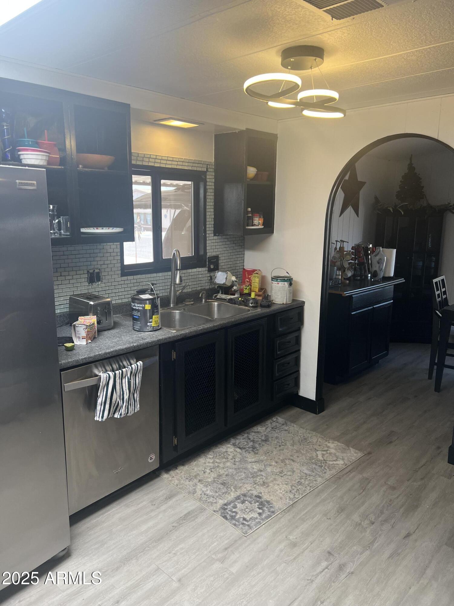 3330 East Main Street, Unit 319 Mesa, AZ 85213 - Photo 11 of 14 a kitchen with granite countertop a stove and cabinets