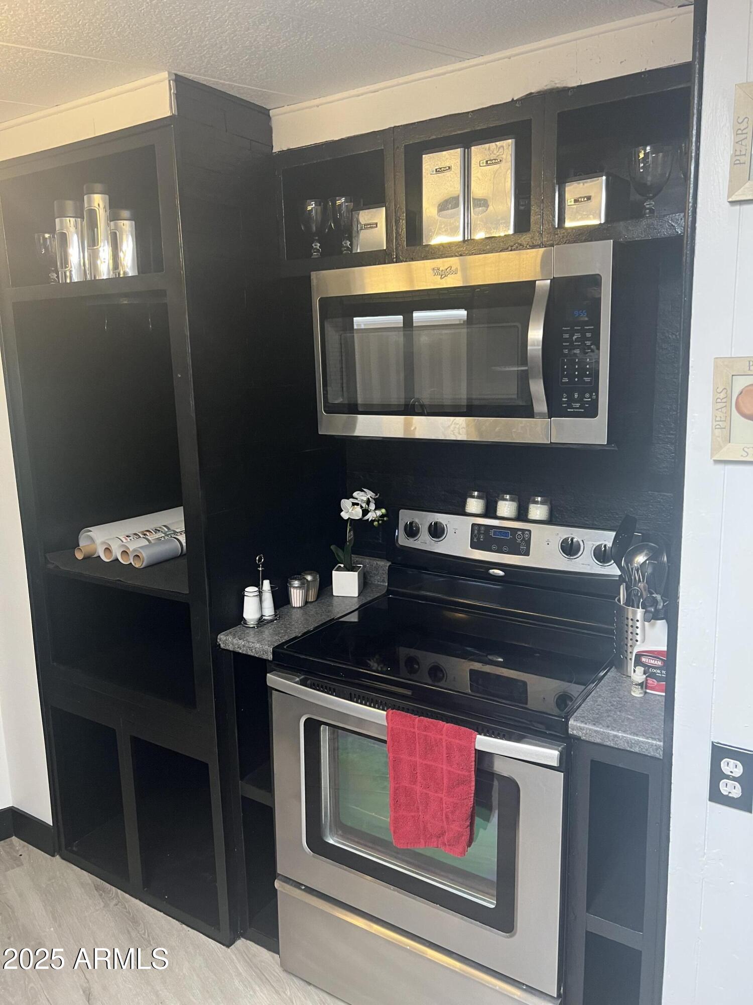3330 East Main Street, Unit 319 Mesa, AZ 85213 - Photo 12 of 14 a kitchen with a stove and a microwave