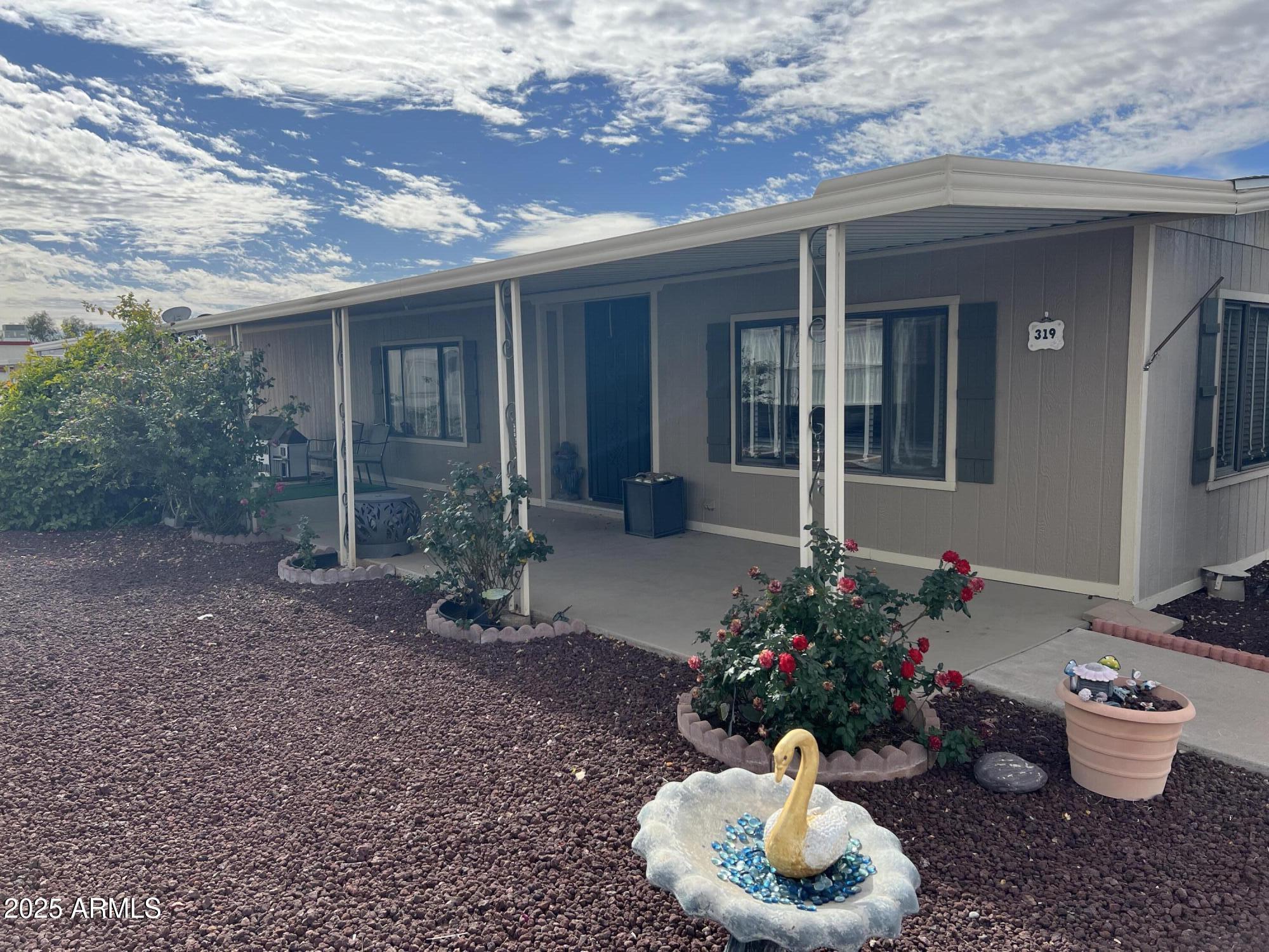 3330 East Main Street, Unit 319 Mesa, AZ 85213 - Photo 3 of 14 a front view of a house with a garden