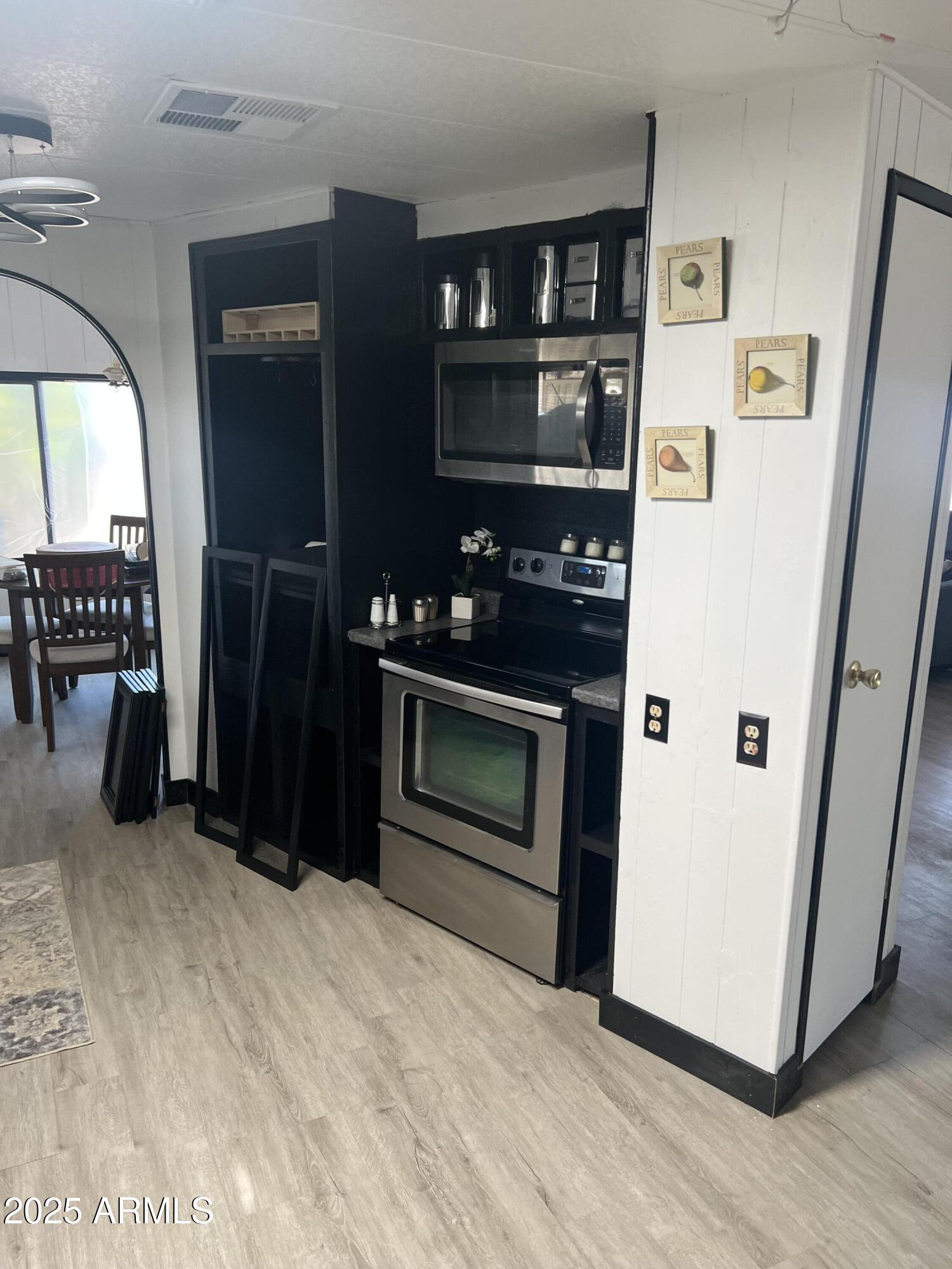 3330 East Main Street, Unit 319 Mesa, AZ 85213 - Photo 4 of 14 a kitchen with stainless steel appliances granite countertop a refrigerator and a stove