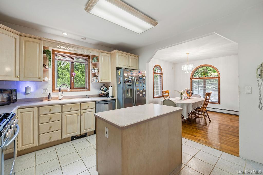 289 Seven Springs Mountain Road Monroe, NY 10950 - Photo 8 of 25 a large kitchen with kitchen island a large window a sink and cabinets
