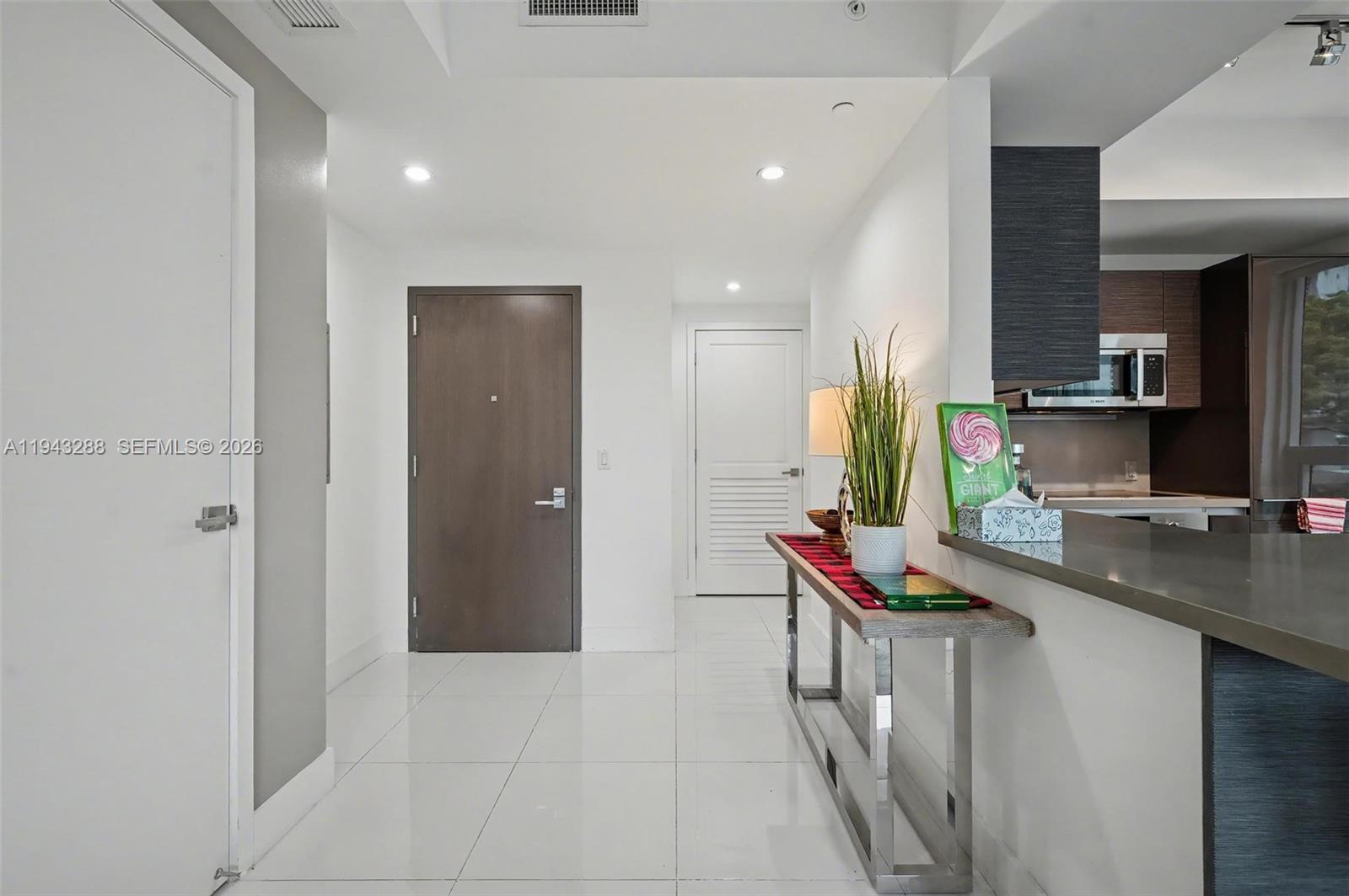 1080 Brickell Avenue, Unit 209 Miami, FL 33131 - Photo 11 of 37 a hallway with washer and dryer