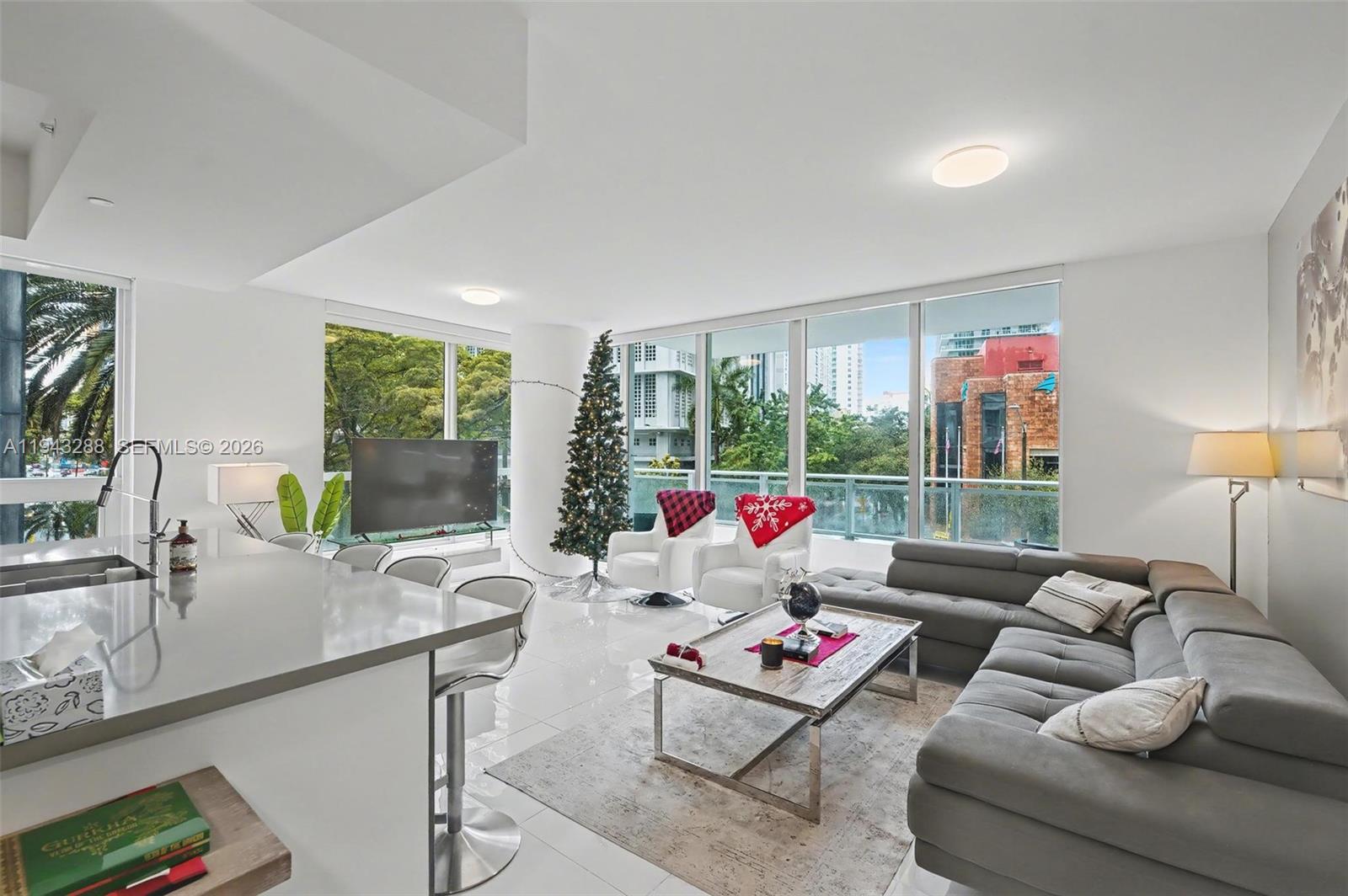 1080 Brickell Avenue, Unit 209 Miami, FL 33131 - Photo 13 of 37 a living room with furniture and a large window