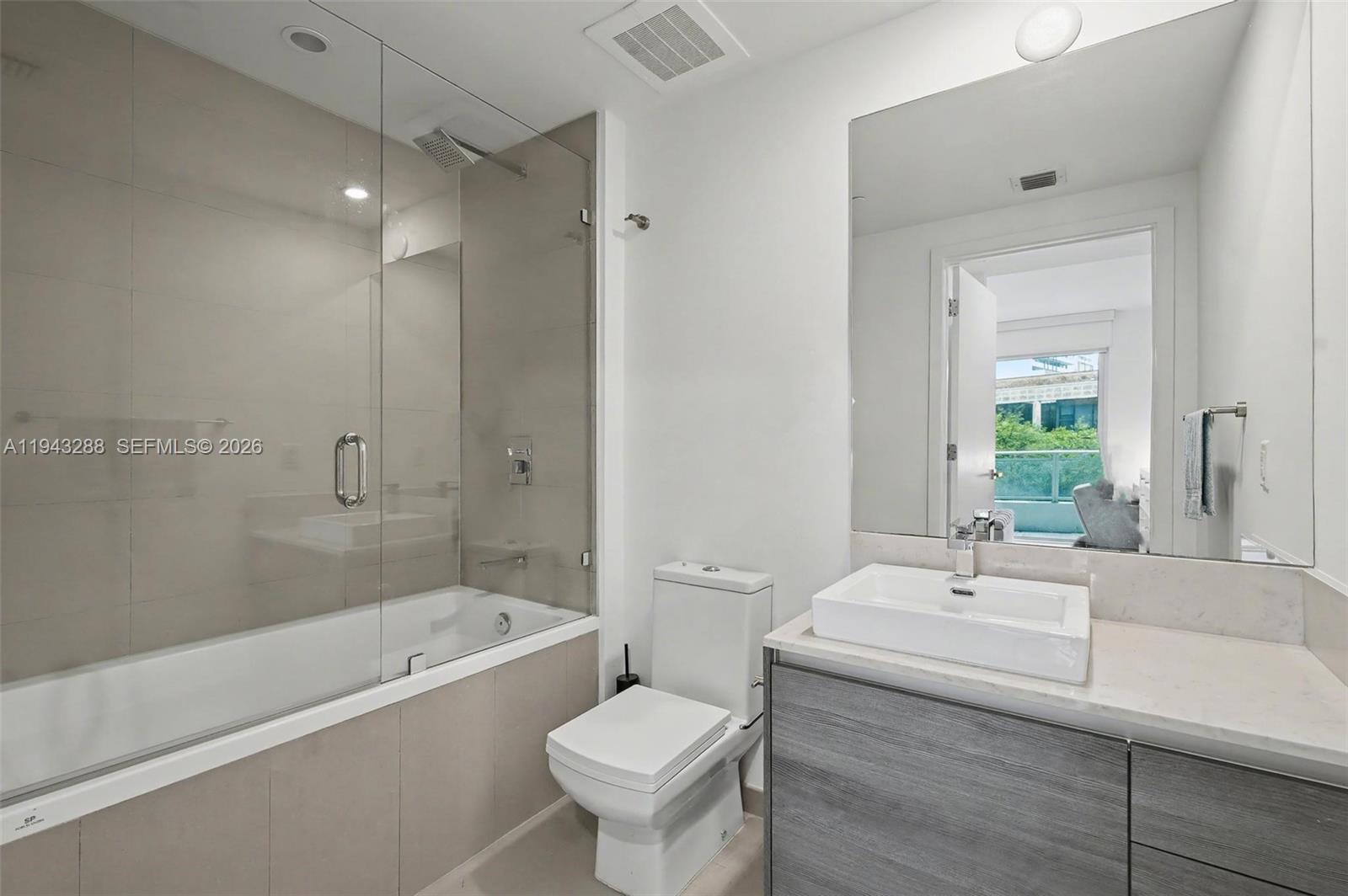1080 Brickell Avenue, Unit 209 Miami, FL 33131 - Photo 20 of 37 a bathroom with a sink toilet and bathtub