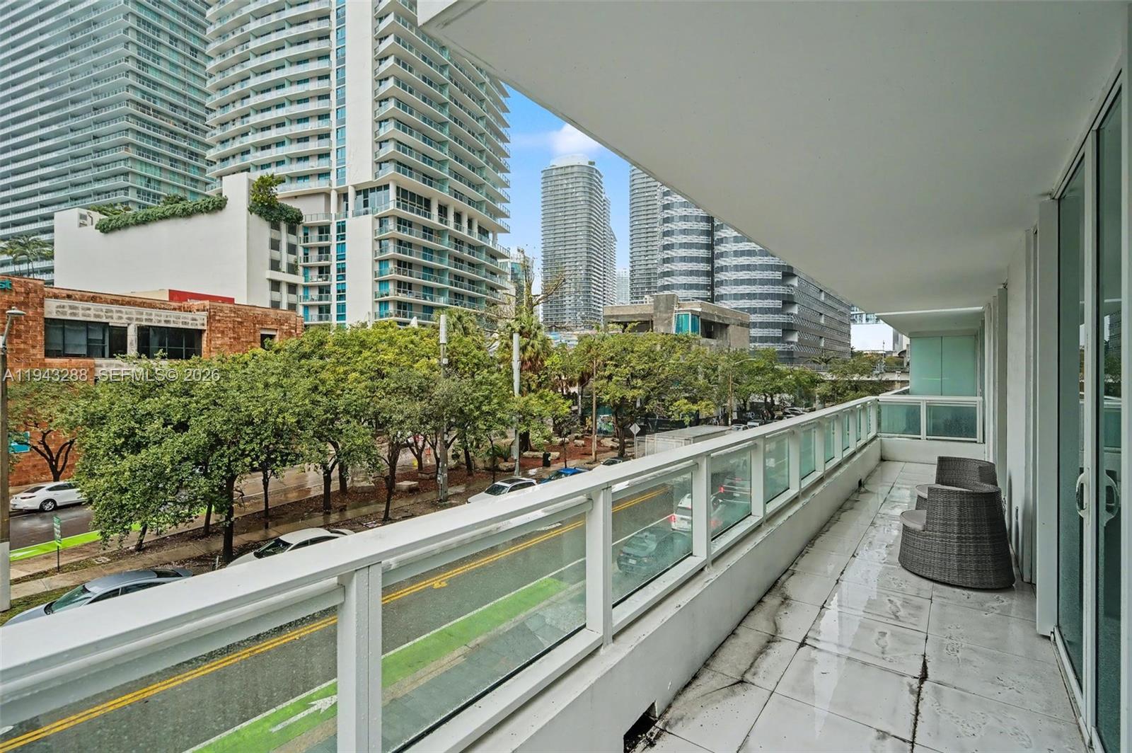 1080 Brickell Avenue, Unit 209 Miami, FL 33131 - Photo 25 of 37 a view of a balcony with chairs