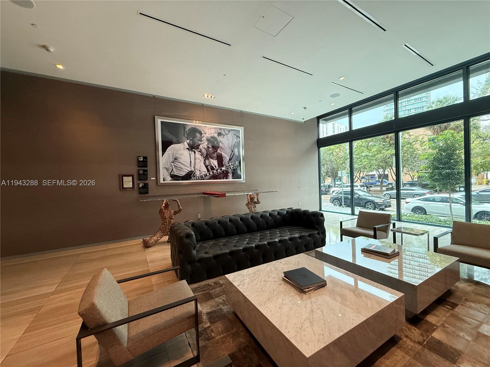 1080 Brickell Avenue, Unit 209 Miami, FL 33131 - Photo 29 of 37 a living room with furniture and a floor to ceiling window