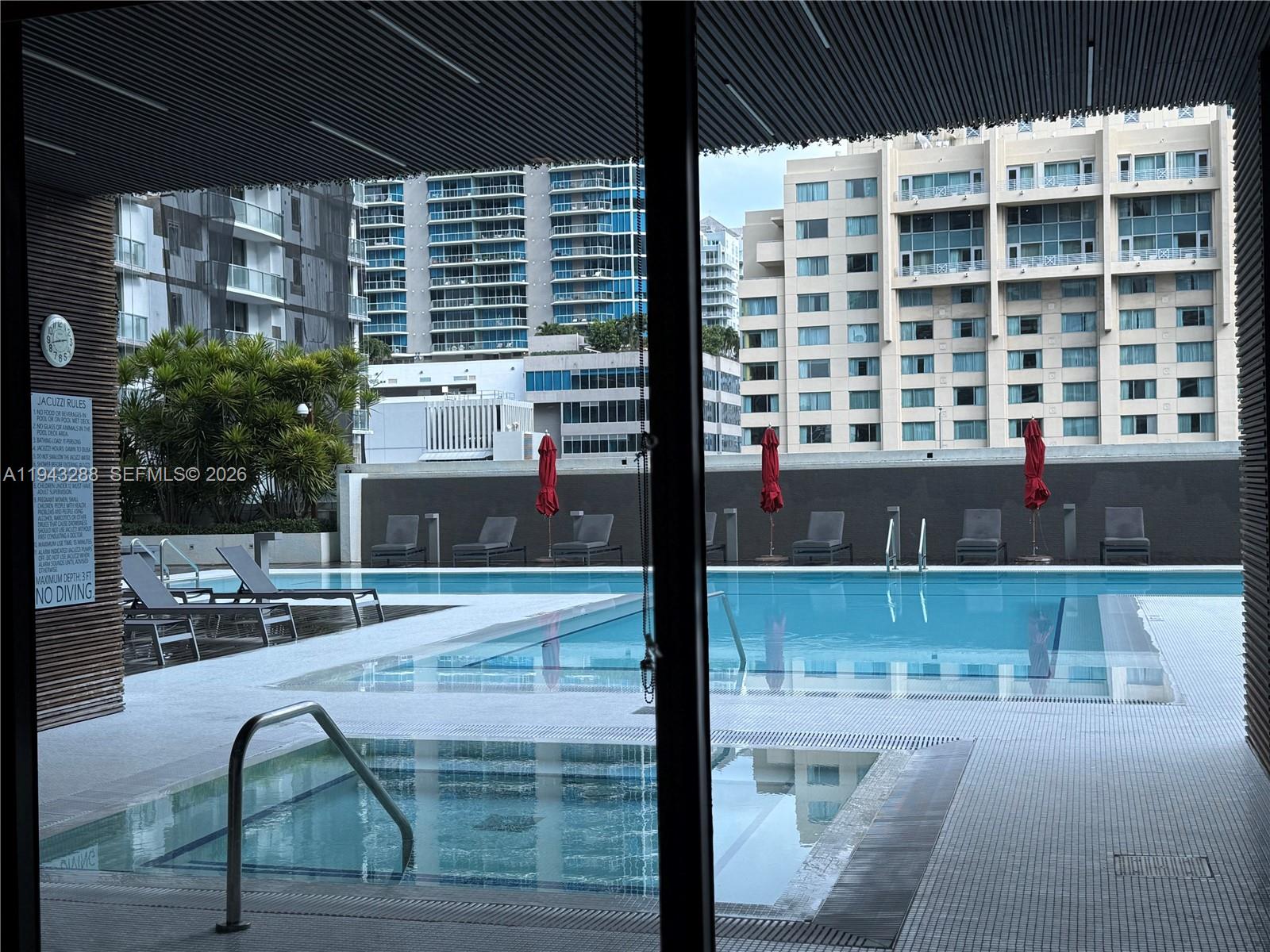1080 Brickell Avenue, Unit 209 Miami, FL 33131 - Photo 32 of 37 a view of swimming pool with outdoor seating and plants