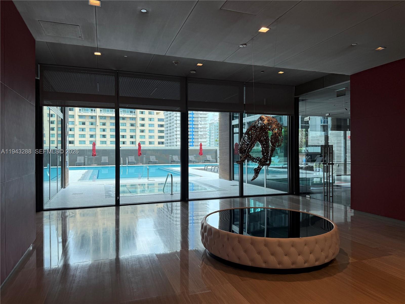 1080 Brickell Avenue, Unit 209 Miami, FL 33131 - Photo 35 of 37 a lobby with furniture and floor to ceiling window