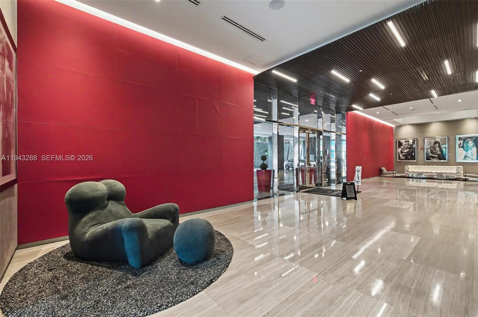 1080 Brickell Avenue, Unit 209 Miami, FL 33131 - Photo 5 of 37 a room with lots of potted plants and a chandelier
