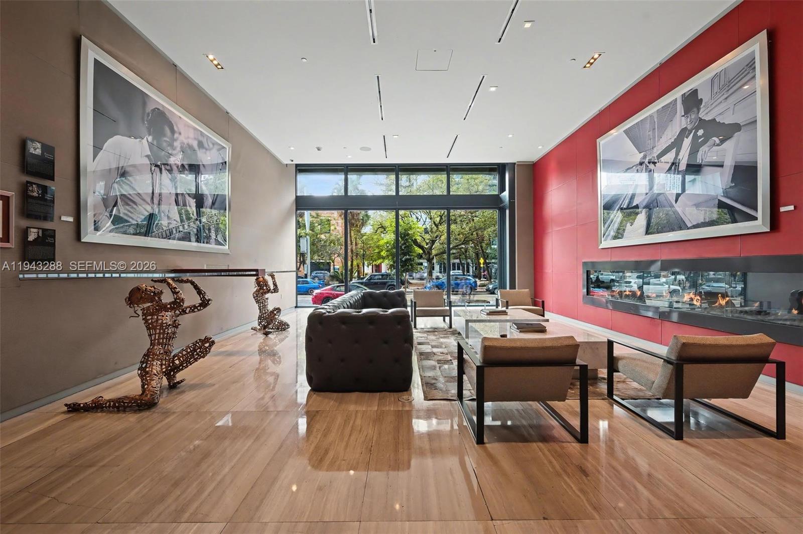 1080 Brickell Avenue, Unit 209 Miami, FL 33131 - Photo 7 of 37 a living room with furniture a large window and wooden floor