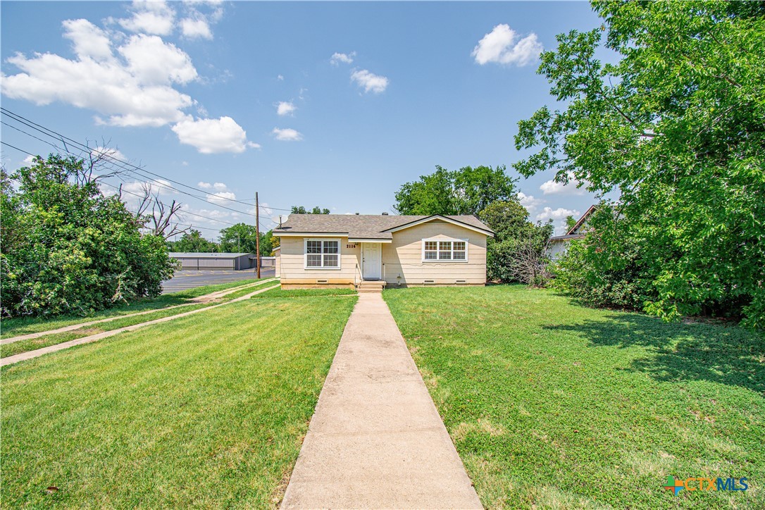 a front view of a house with yard