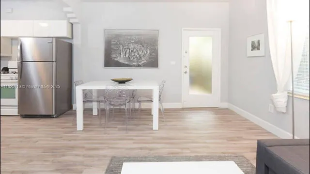 a kitchen with granite countertop a refrigerator and a stove top oven