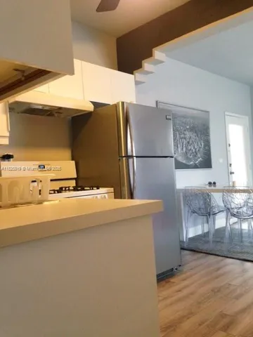 a view of kitchen and wooden floor