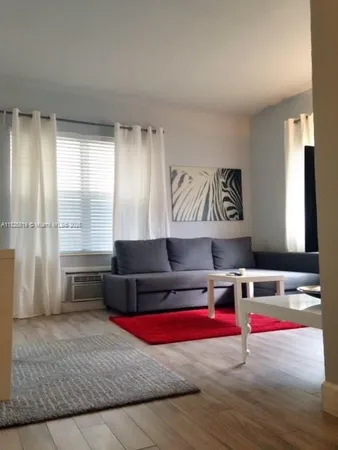 a living room with furniture and window