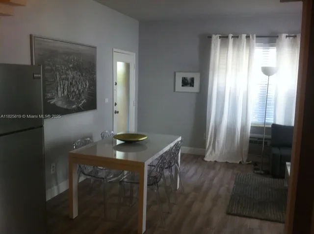 a view of a room that has a table and a chair in it