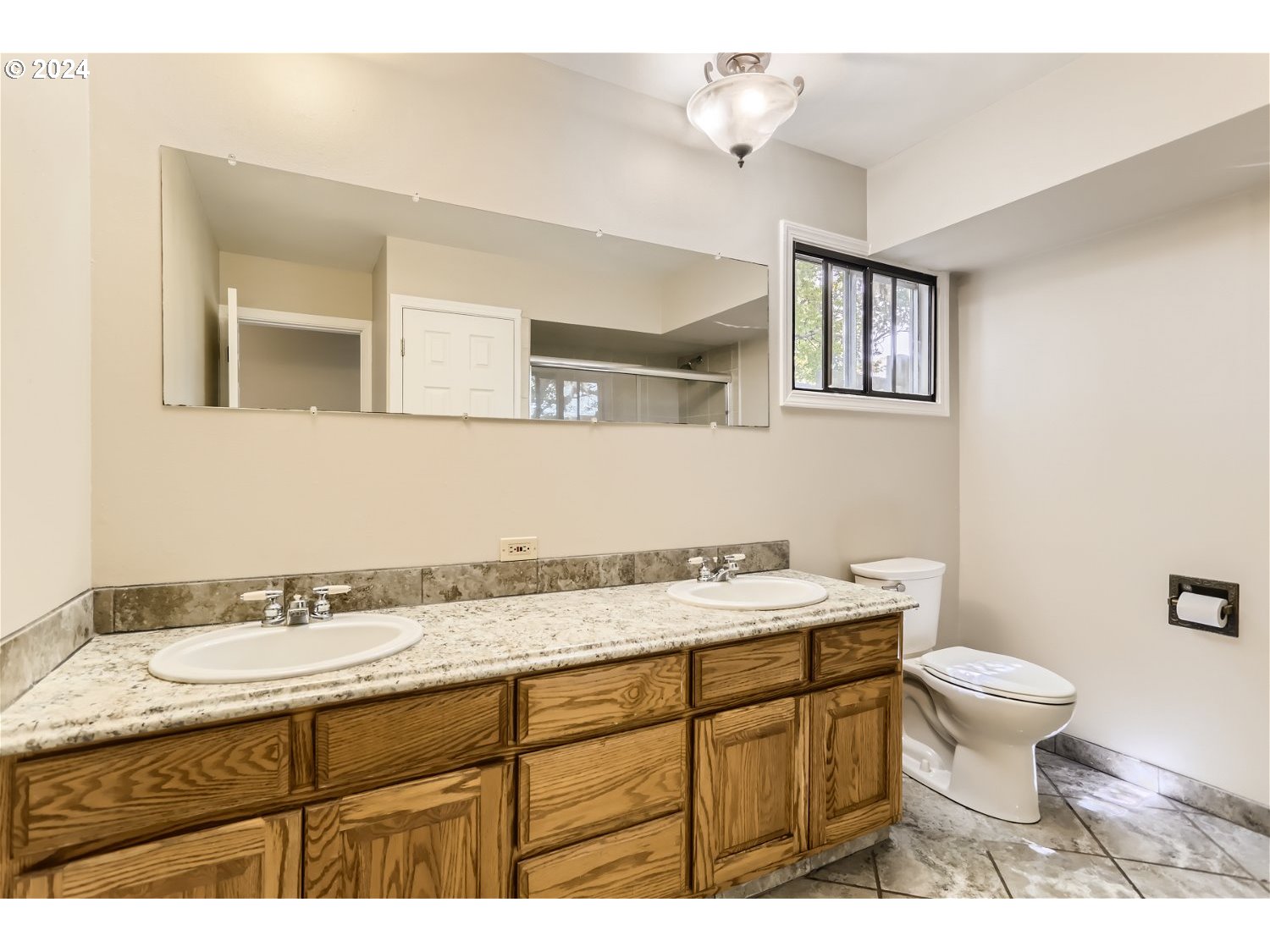 4009 Southeast View Acres Road Milwaukie, OR 97267 - Photo 17 of 37 a bathroom with a granite countertop sink toilet and mirror