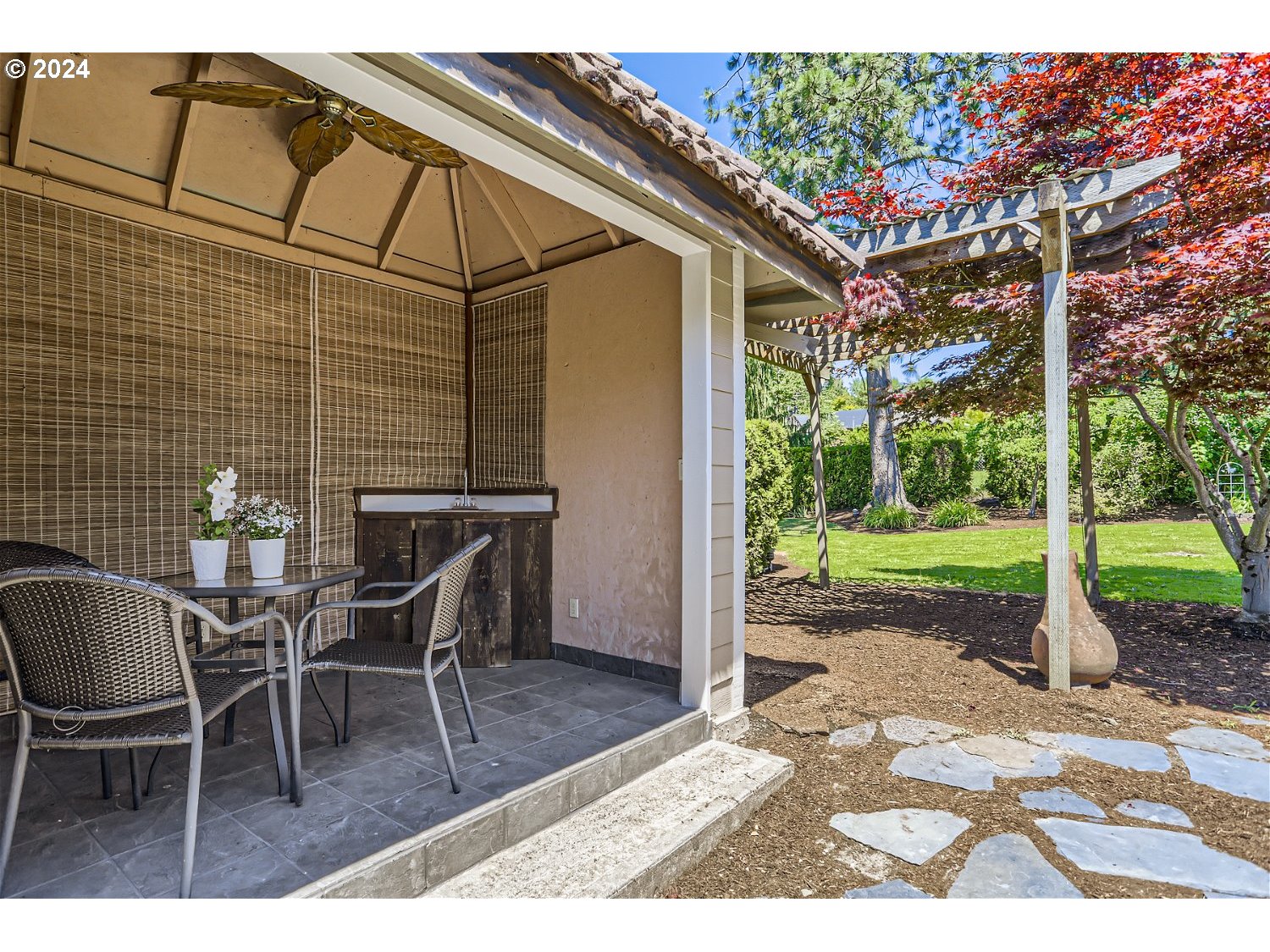 4009 Southeast View Acres Road Milwaukie, OR 97267 - Photo 30 of 37 a backyard of a house with barbeque oven table and chairs