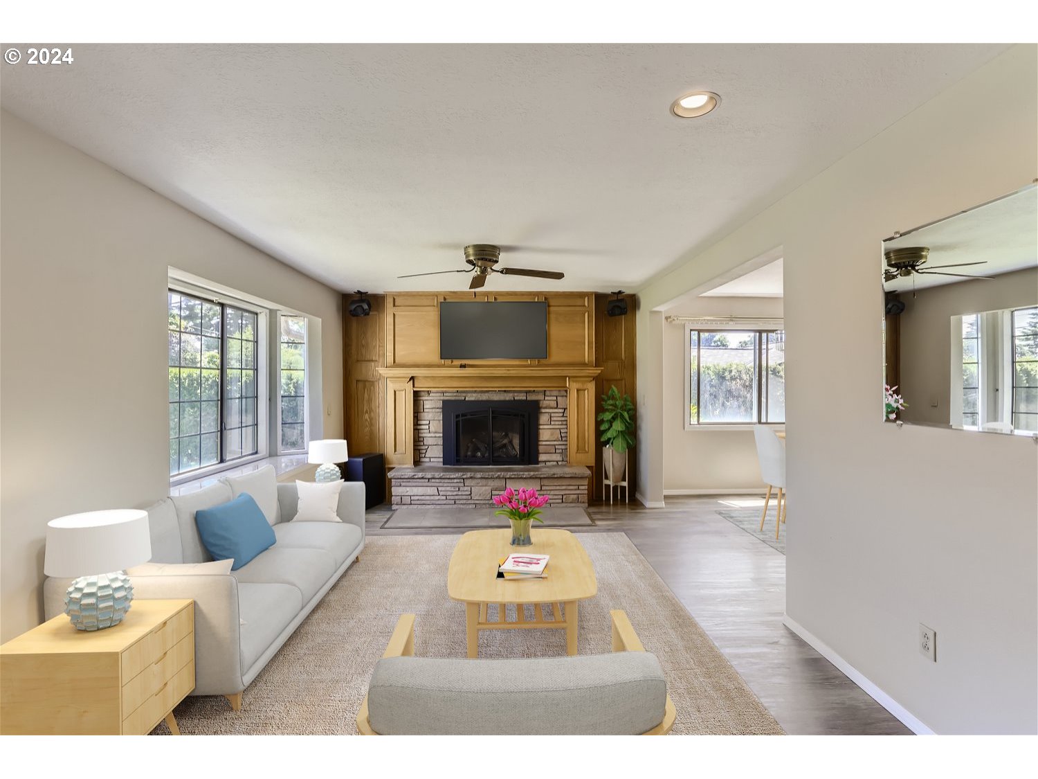 4009 Southeast View Acres Road Milwaukie, OR 97267 - Photo 6 of 37 a living room with furniture a fireplace and a flat screen tv