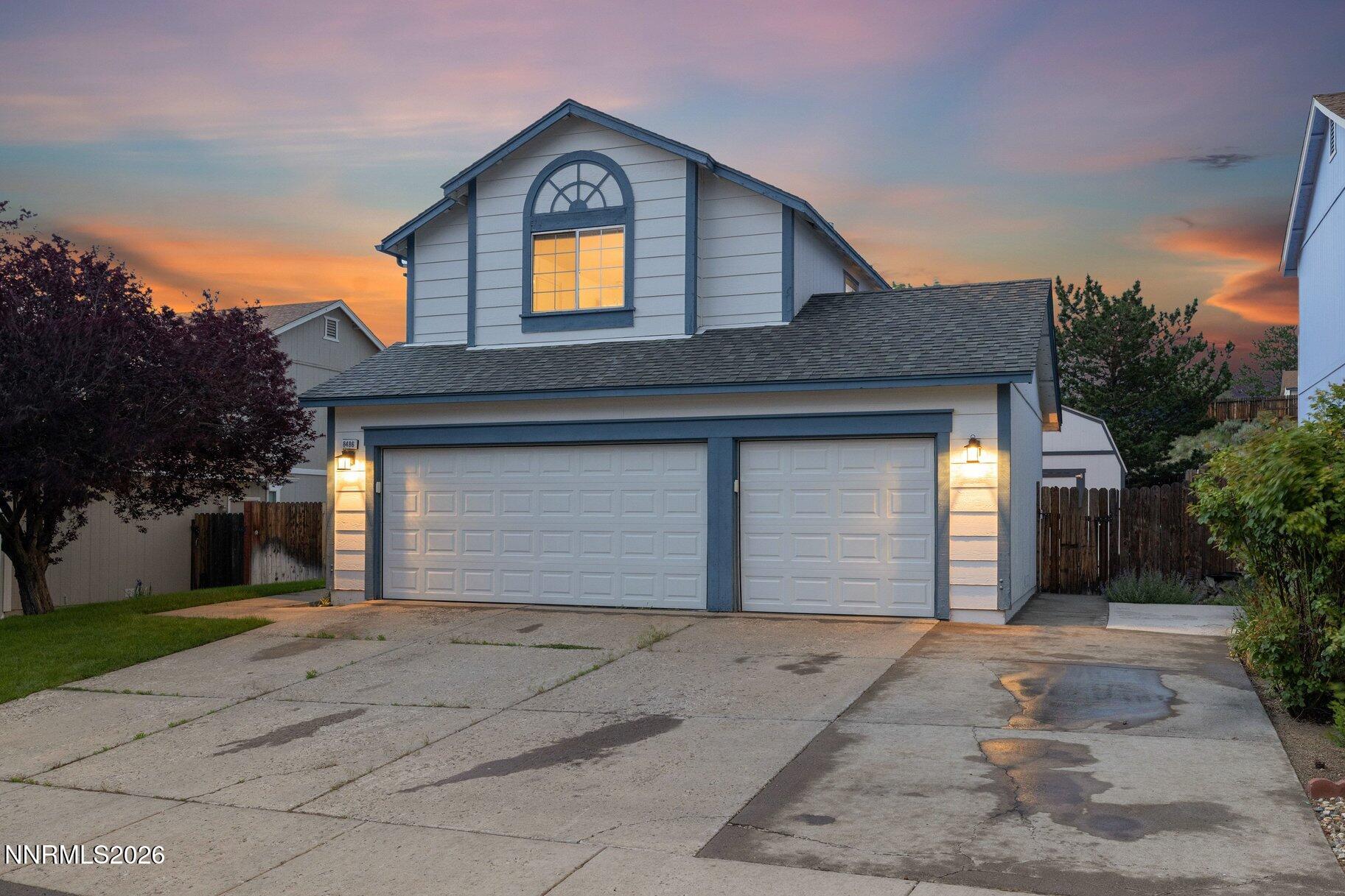 8486 Piper Place Reno, NV 89506 - Photo 69 of 80 a front view of a house with a yard and garage