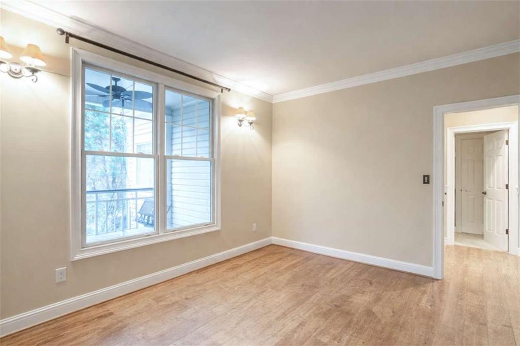 1660 A Maple Ridge Drive Loganville, GA 30052 - Photo 16 of 51 a view of an empty room with a window and wooden floor