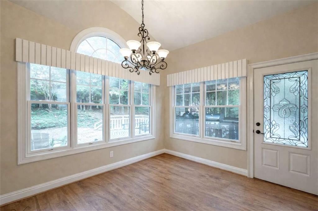 1660 A Maple Ridge Drive Loganville, GA 30052 - Photo 22 of 51 a view of an empty room with wooden floor and a window