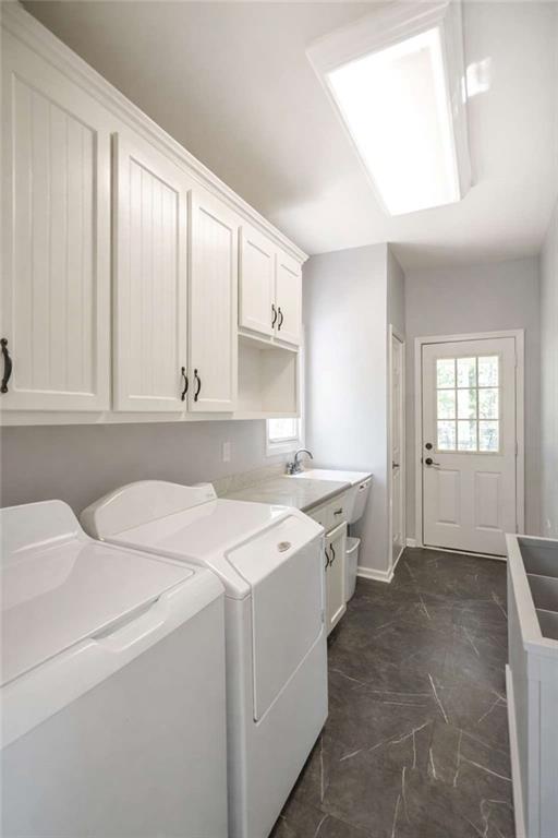 1660 A Maple Ridge Drive Loganville, GA 30052 - Photo 24 of 51 a utility room with cabinets washer and dryer