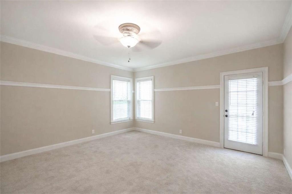 1660 A Maple Ridge Drive Loganville, GA 30052 - Photo 26 of 51 an empty room with windows and chandelier fan